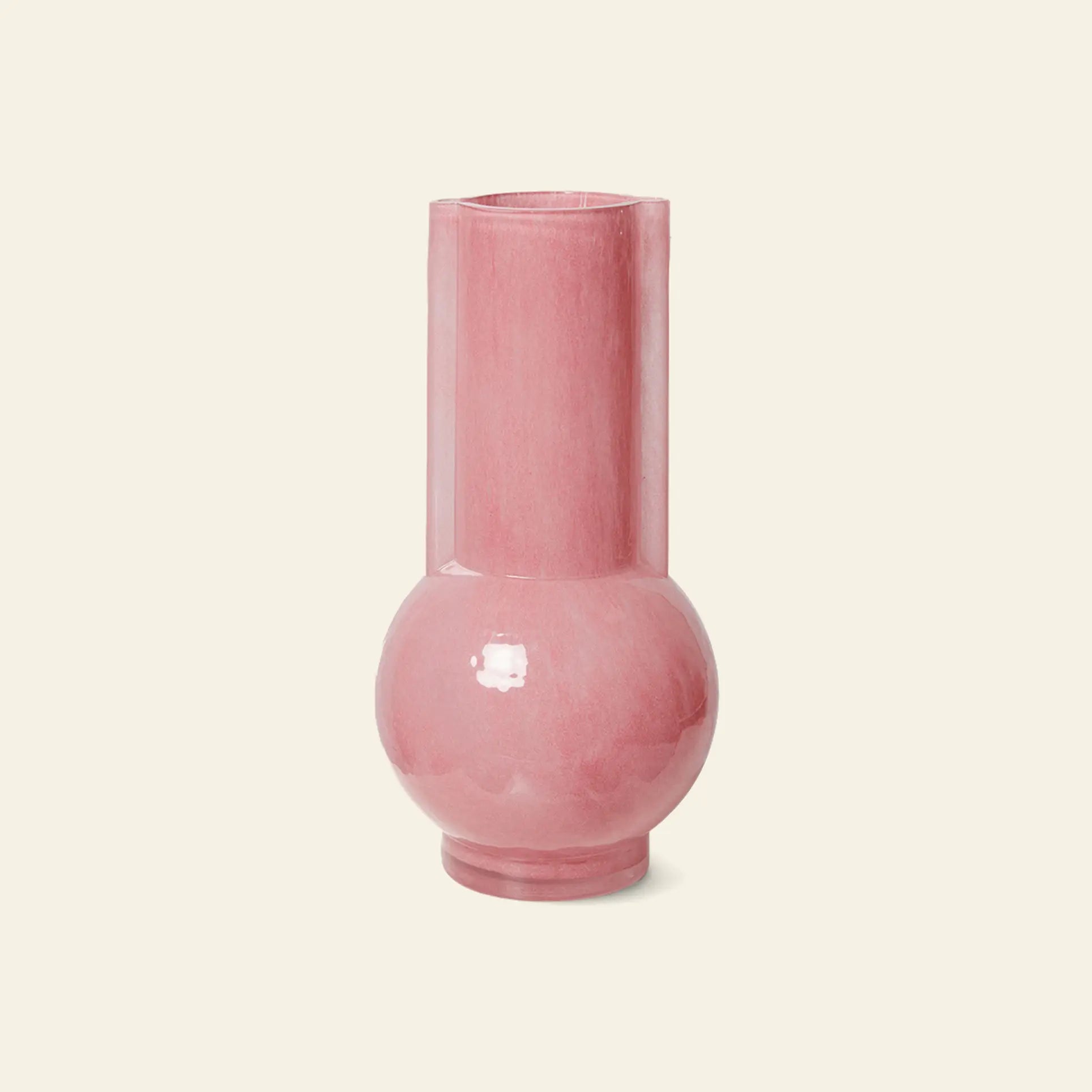 The HKliving Glass Vase Flamingo Pink by HKliving features a tall, glossy pink finish with a cylindrical top and rounded base, making it a chic accent that brightens any room against an off-white backdrop.