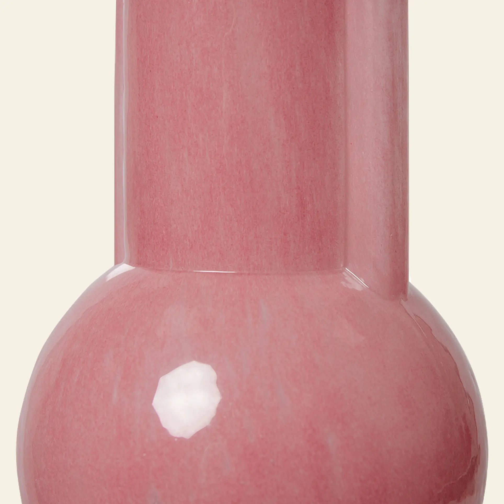 Close-up of the HKliving Glass Vase Flamingo Pink—a glossy, milky pink ceramic vase with a round base and tall neck. Its reflective surface by HKliving adds a bright touch to any space, set against a plain light background.