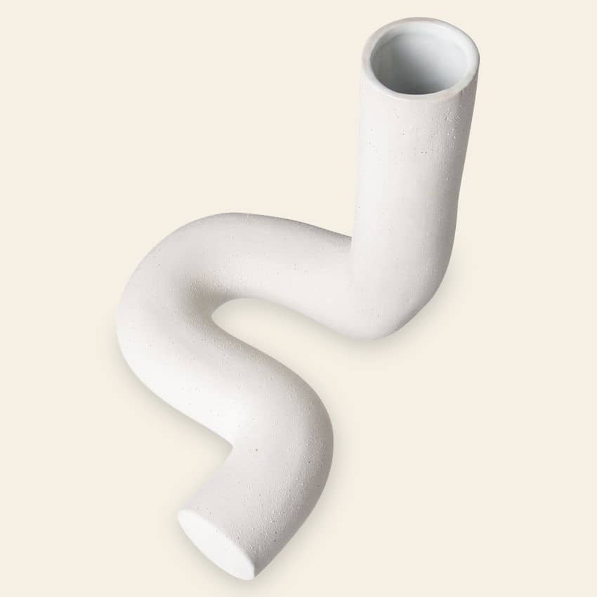 The HKliving HK Objects: Ceramic Twisted Vase by HKliving showcases a modern, sculptural S-shaped design on a light beige background—ideal for enhancing your home decor.