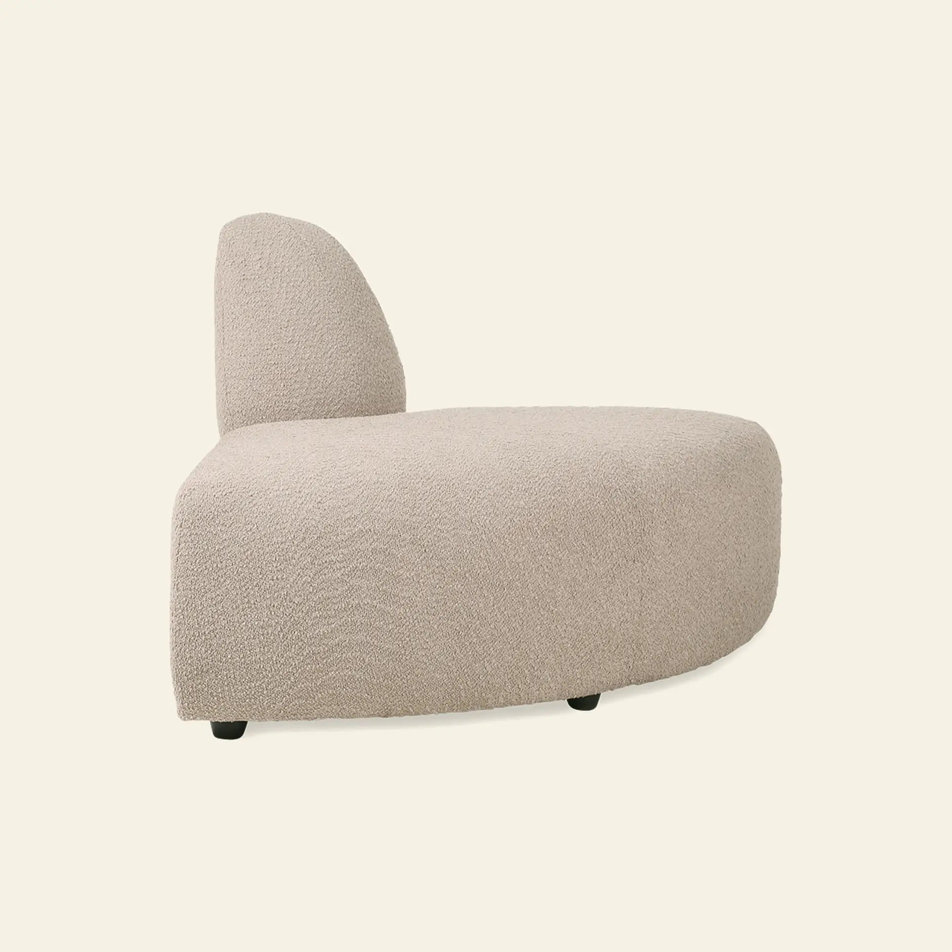 The HKliving Jax Couch, Angle by HKliving features a modern armless design with a curved backrest and seat in textured light beige fabric, highlighted against a plain off-white background.