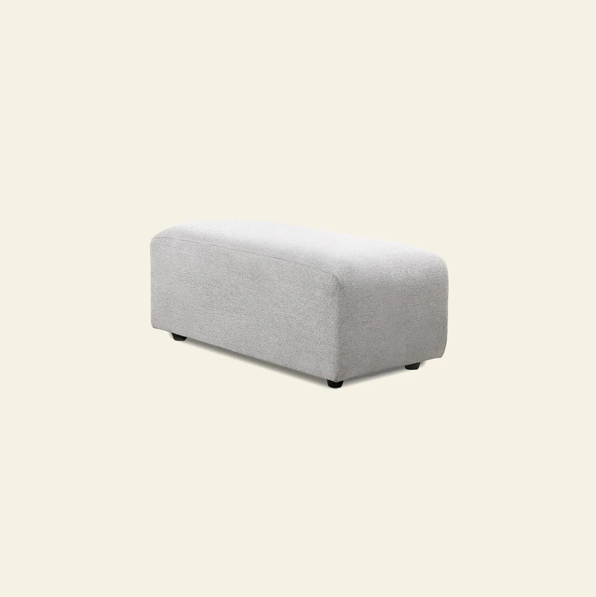 The HKliving Jax Couch, Hocker Small by HKliving is a rectangular, light gray upholstered ottoman with rounded edges and small black feet, adding versatile style to any space against a plain off-white background.