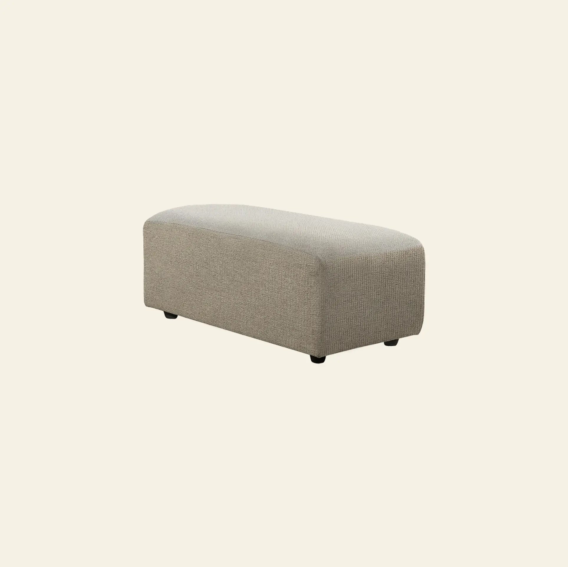 The HKliving Jax Couch, Hocker Small is a rectangular ottoman in light gray fabric with rounded edges and short black legs, reflecting the versatile Jax design by HKliving, set against an off-white background.