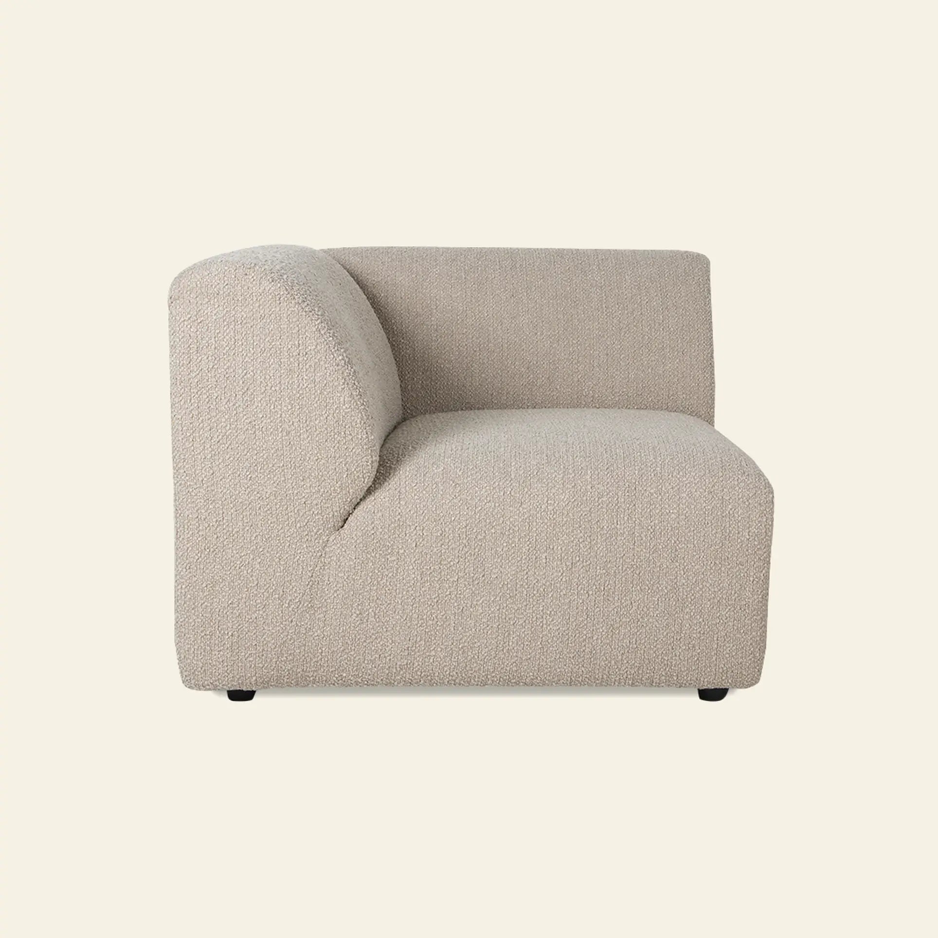 The HKliving Jax Couch, Left End by HKliving is a modern, armless beige sectional with a curved backrest and plush textured upholstery, displayed against a plain light background.