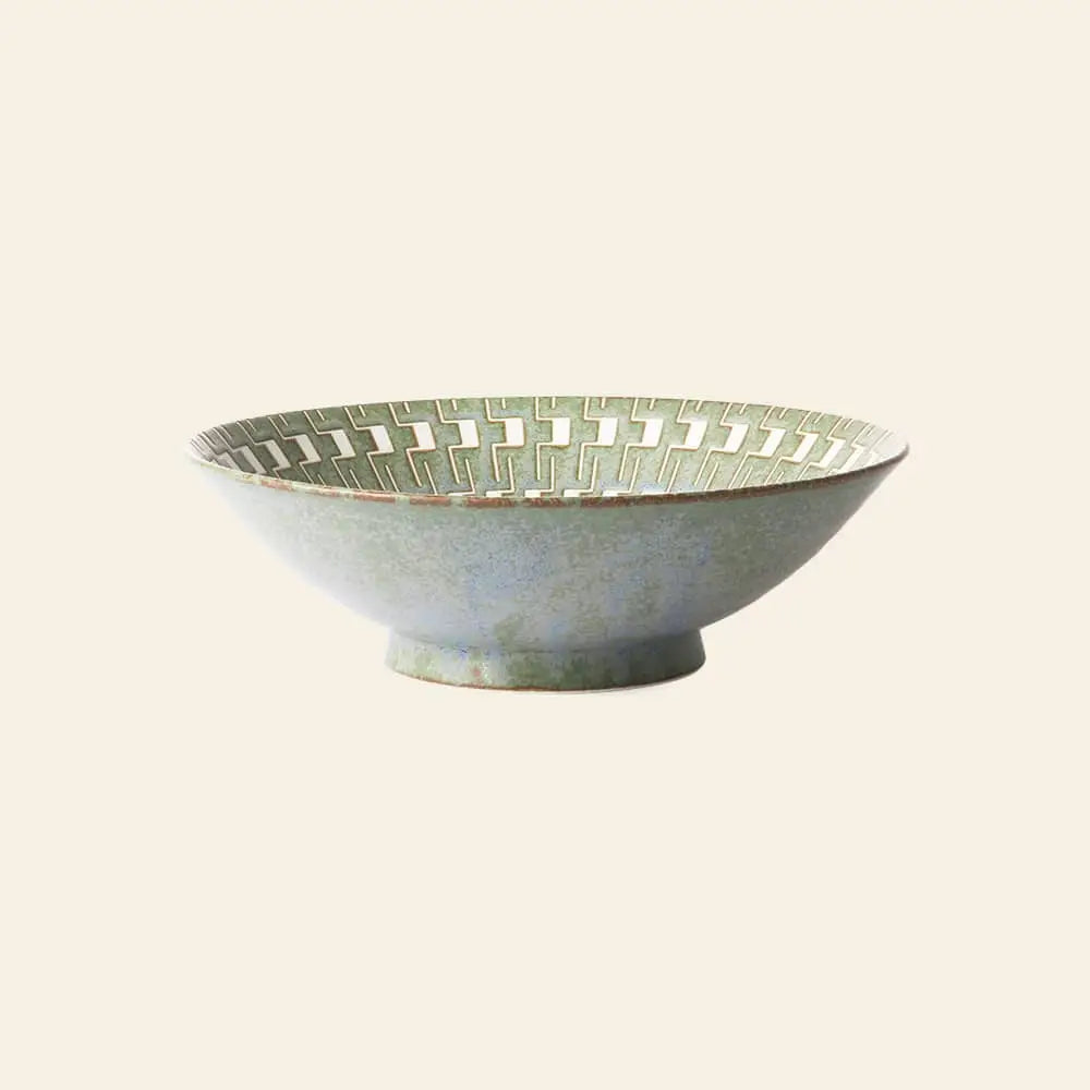 The HKliving Kyoto Ceramics: Japanese Ceramic Salad Bowl features a greenish glaze, interlocking geometric rim, and subtle gradient, with a small round base evoking Japanese tea ceremony style—set against a plain beige background.