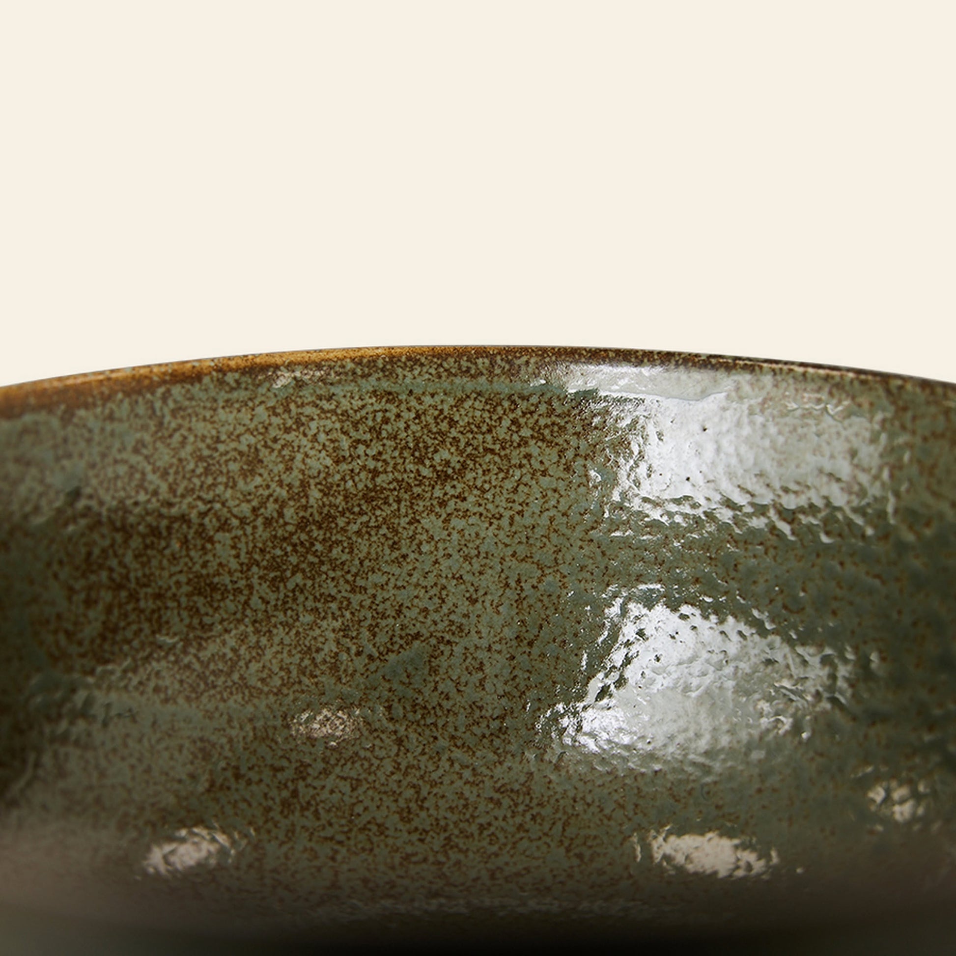 Close-up of the rim and side of an HKliving Kyoto Ceramics Japanese Noodle Bowl, set of 4, featuring a hand-finished mottled green and brown glaze inspired by Kyoto ceramics, shown against a plain light background.