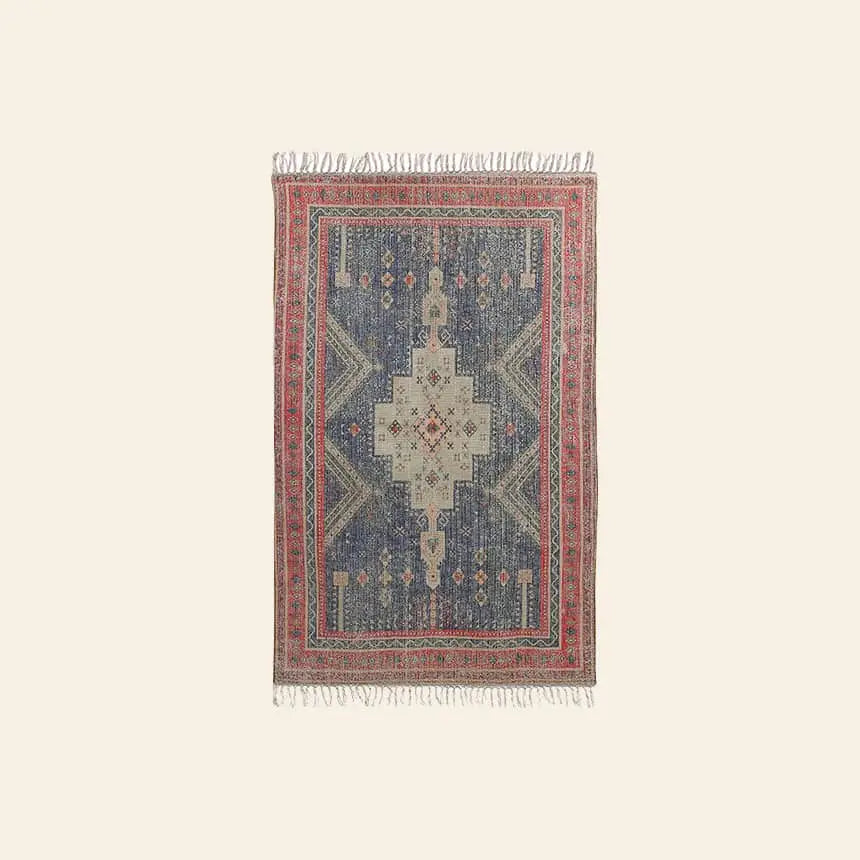The HKliving Printed Rug Overtufted (150x240) features a central beige and blue geometric medallion, intricate patterns, a red border, short tassels on each end, and an anti-slip backing for safety. Brand: HKliving.