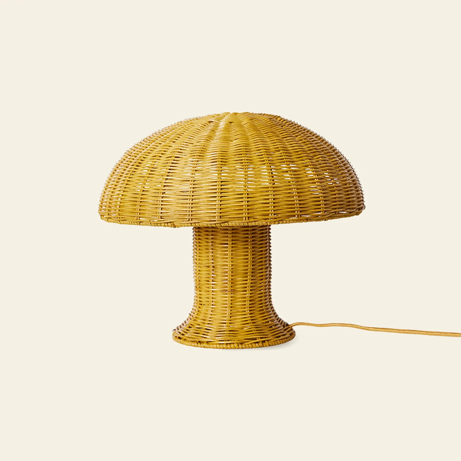 The HKliving Rattan Table Lamp by HKliving features a yellow wicker dome top and cylindrical base, ideal as a cozy mood light. Its cord extends on a beige background, adding rustic country charm to any space.