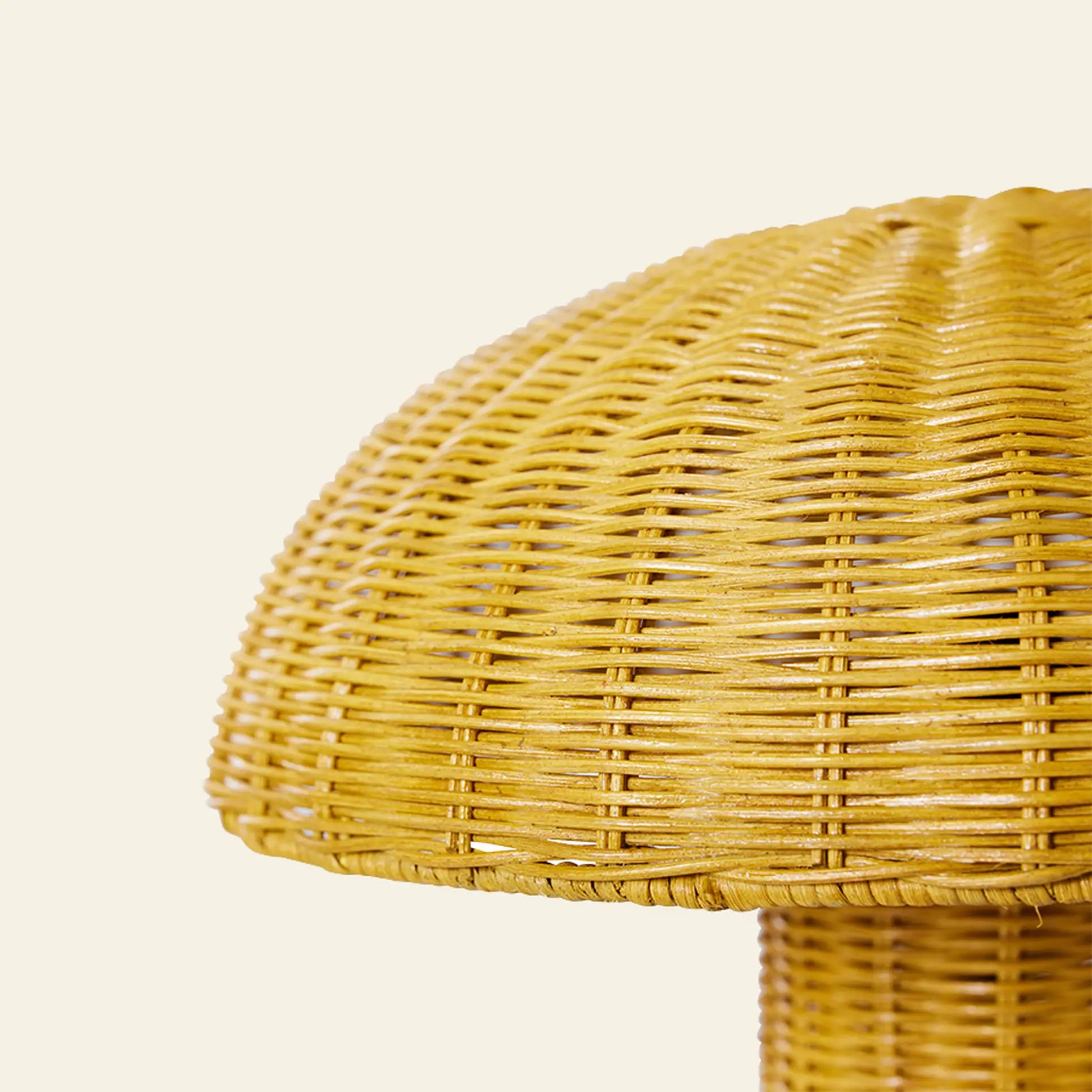 The HKliving Rattan Table Lamp features a mushroom-shaped woven design, casting warm yellow tones against a plain background—ideal for infusing cozy, rustic charm into your country-style decor.