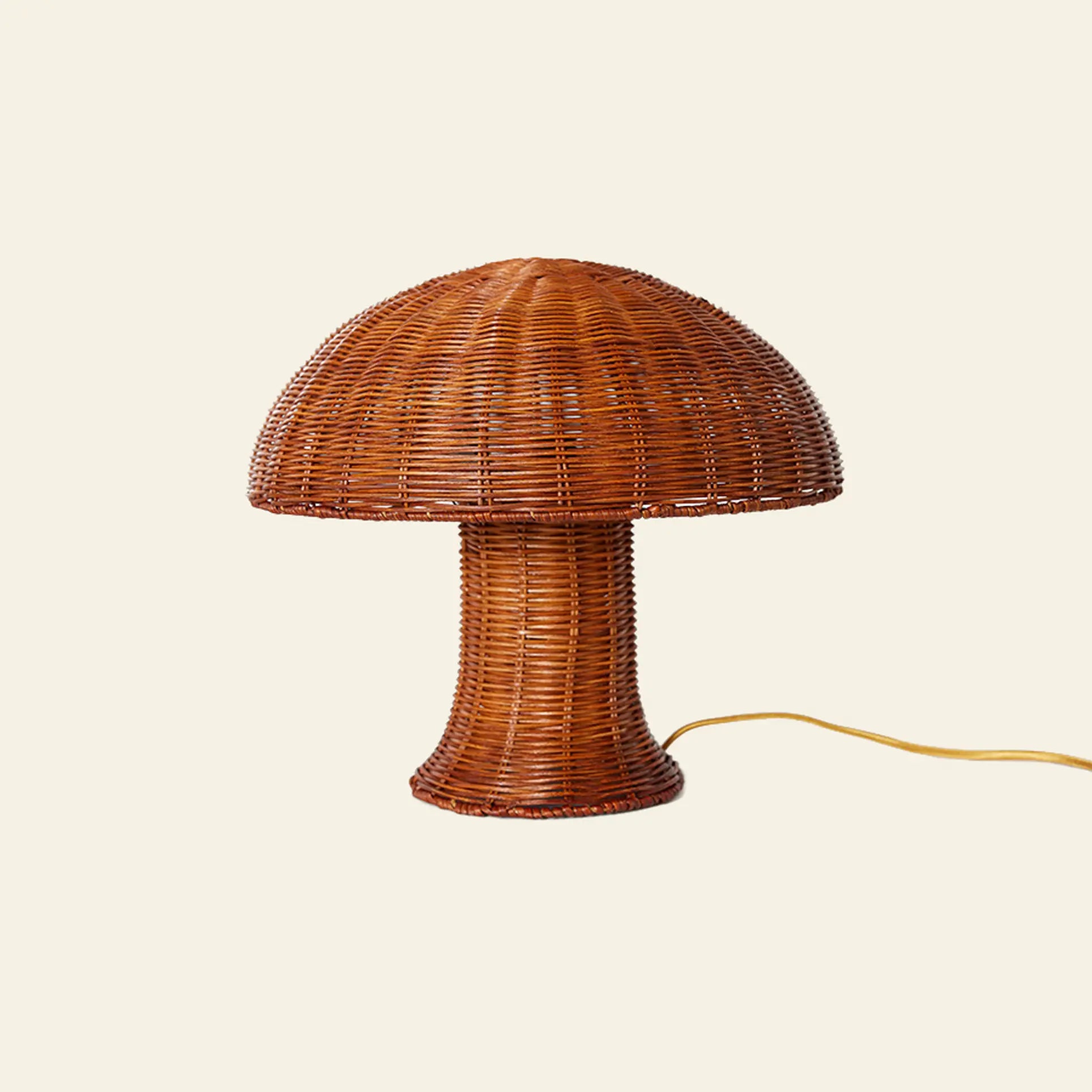 The HKliving Rattan Table Lamp by HKliving features a mushroom-shaped design in woven brown wicker with a visible yellow power cord, set against an off-white background—ideal for bringing country style to your space.