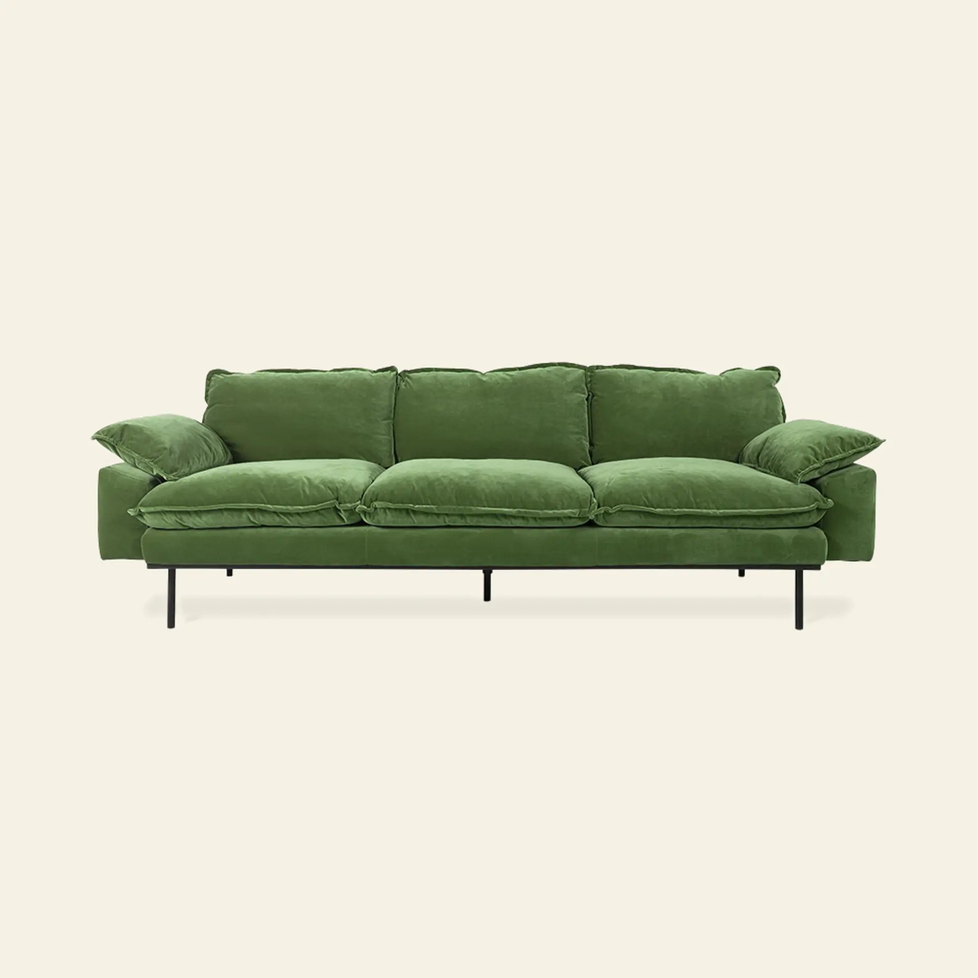 The HKliving Retro Sofa, 4-Seats, by HKliving features plush green velvet cushions and slim black metal legs, delivering exceptional comfort and a bold accent to your living space against a light background.