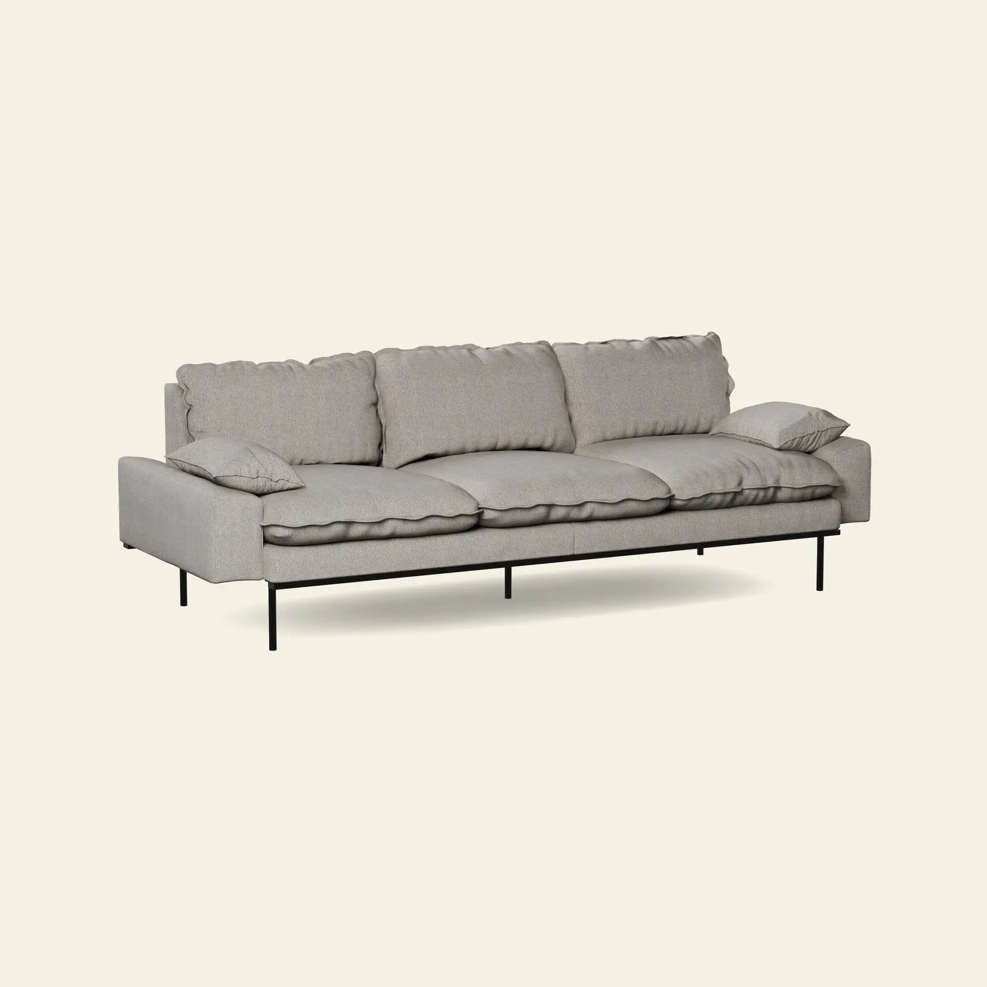 The HKliving Retro Sofa, 4-Seats by HKliving features modern light gray fabric, three seat and back cushions, two side pillows, and slim black metal legs—bringing comfort and style to your space against an off-white backdrop.