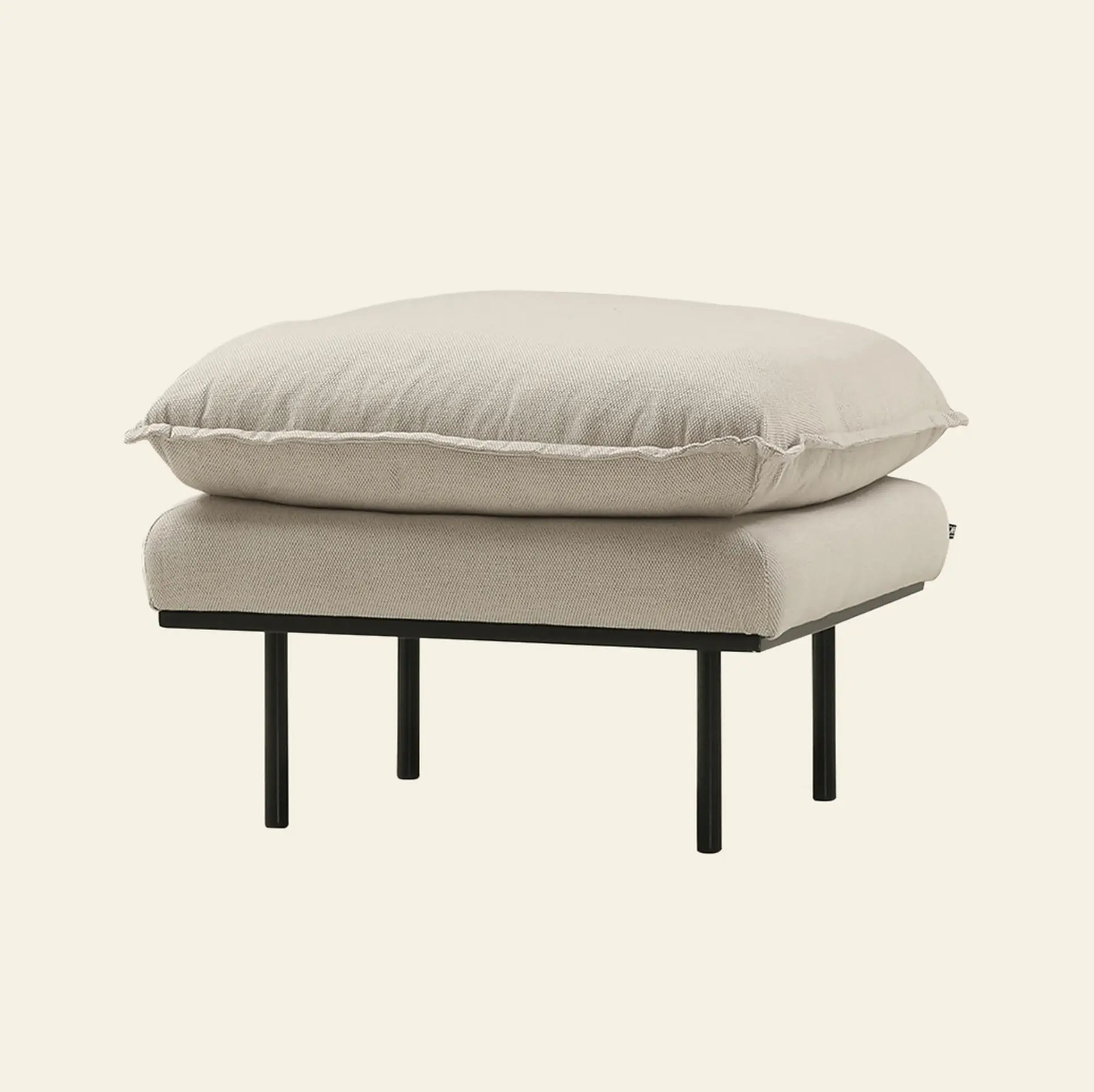 The HKliving Retro Sofa, Hocker by HKliving features a thick light beige cushion on a sleek black metal frame, blending comfort and style for any room. Photographed against an off-white background.