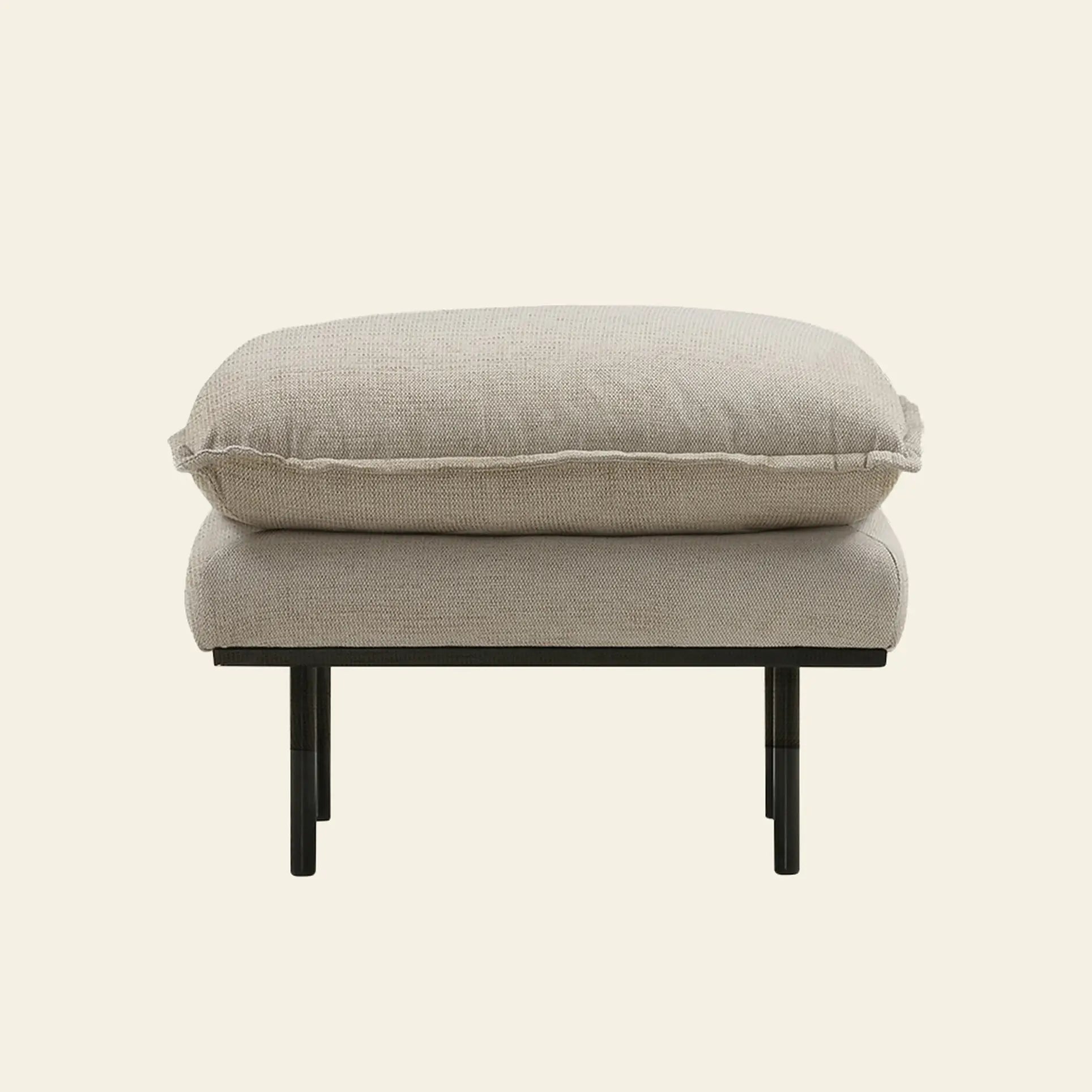 The HKliving Retro Sofa, Hocker by HKliving features a plush cushion and black metal legs in modern beige, showcased against an off-white background—an ideal piece to elevate your living space.
