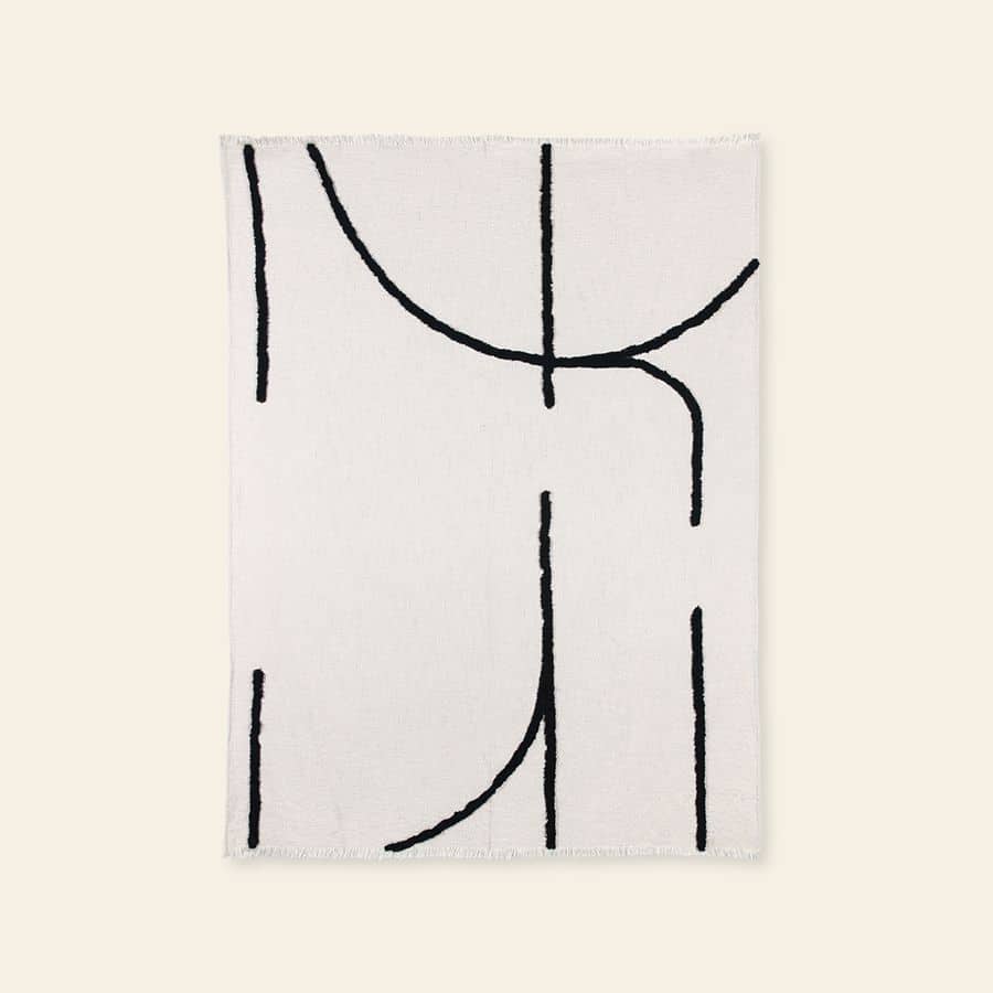 The HKliving Soft Woven Throw With Black Tufted Lines features minimalist black abstract lines on cosy cotton, adding stylish texture to any space. Crafted by HKliving, it perfectly complements modern interiors.
