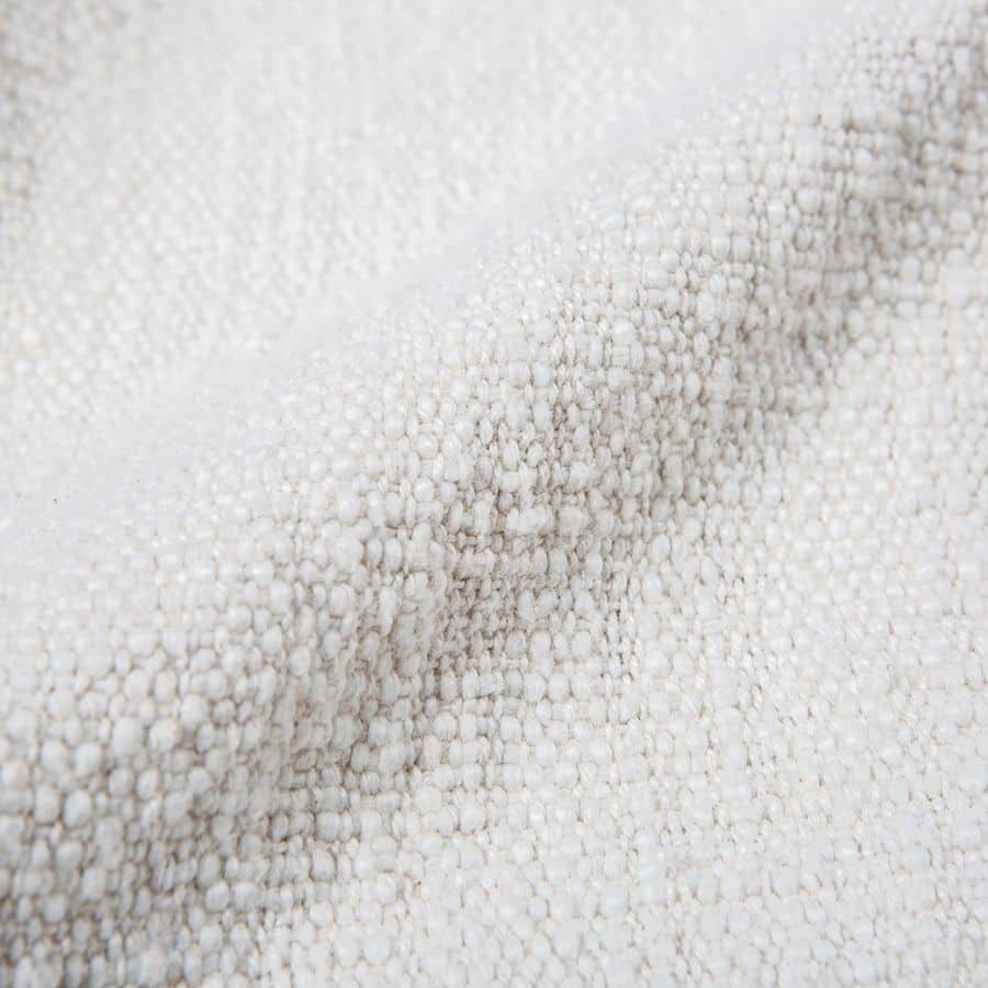 Close-up of the HKliving Soft Woven Throw With Black Tufted Lines by HKliving, featuring white textured fabric with gentle folds and soft appearance—ideal for adding stylish texture to your space.