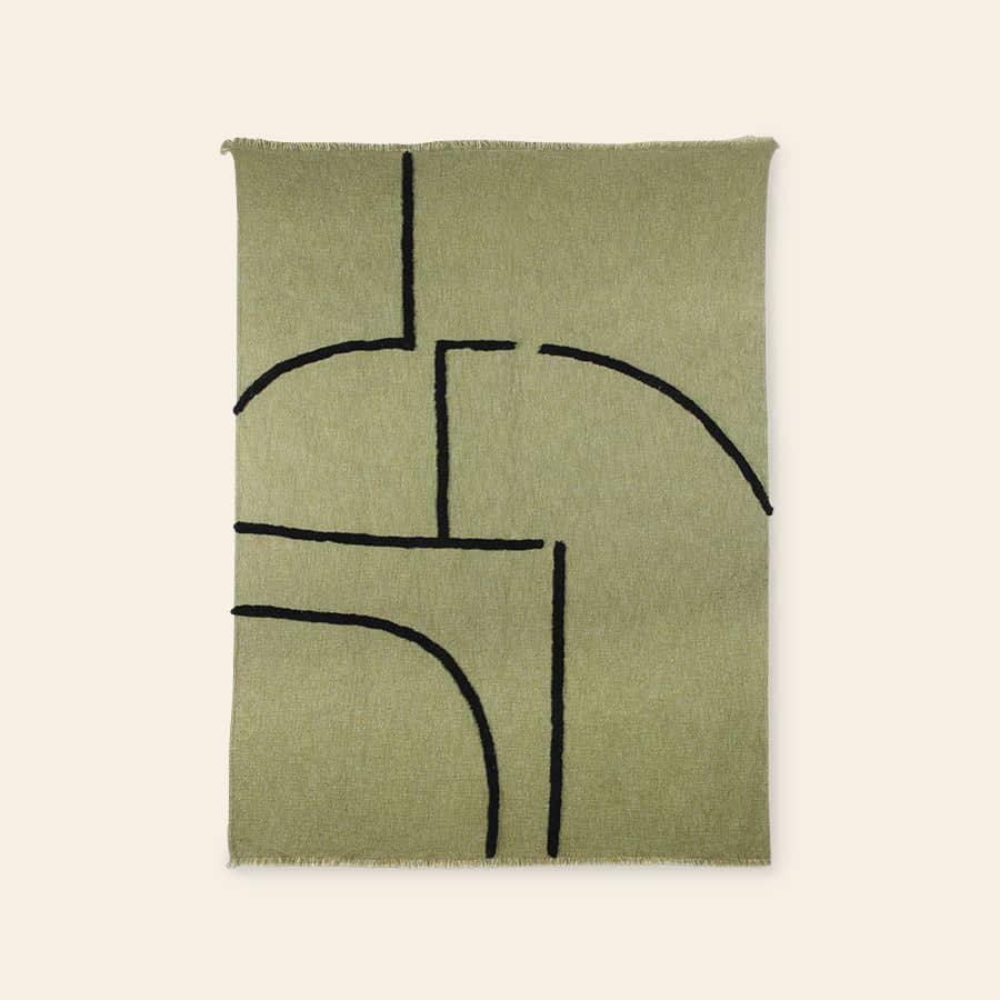 The HKliving Soft Woven Throw With Black Tufted Lines features a minimalist rectangular green design, bold black curved and straight lines, slightly fringed edges, and a cosy cotton-like texture, shown on a neutral background.