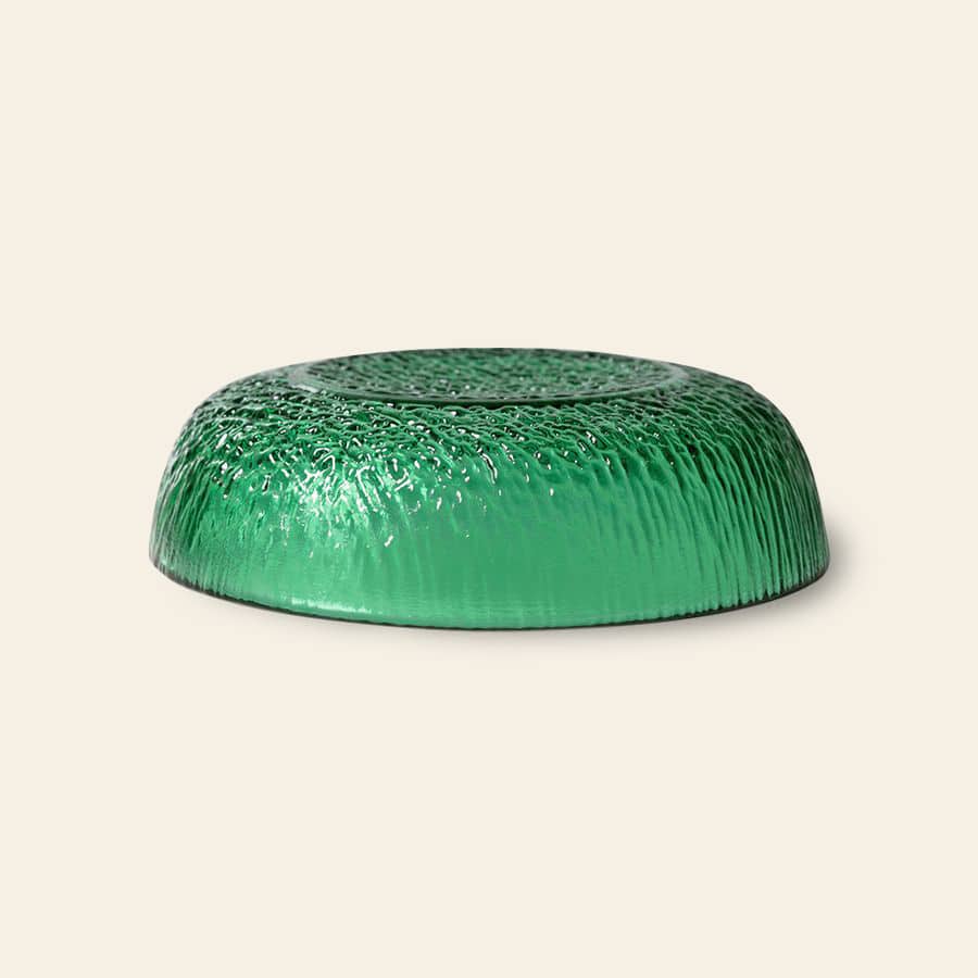 An HKliving The Emeralds: Glass Dessert Bowl by HKliving is displayed upside down on a light beige background, showcasing its rippled, grass-like texture for a modern, elegant look.