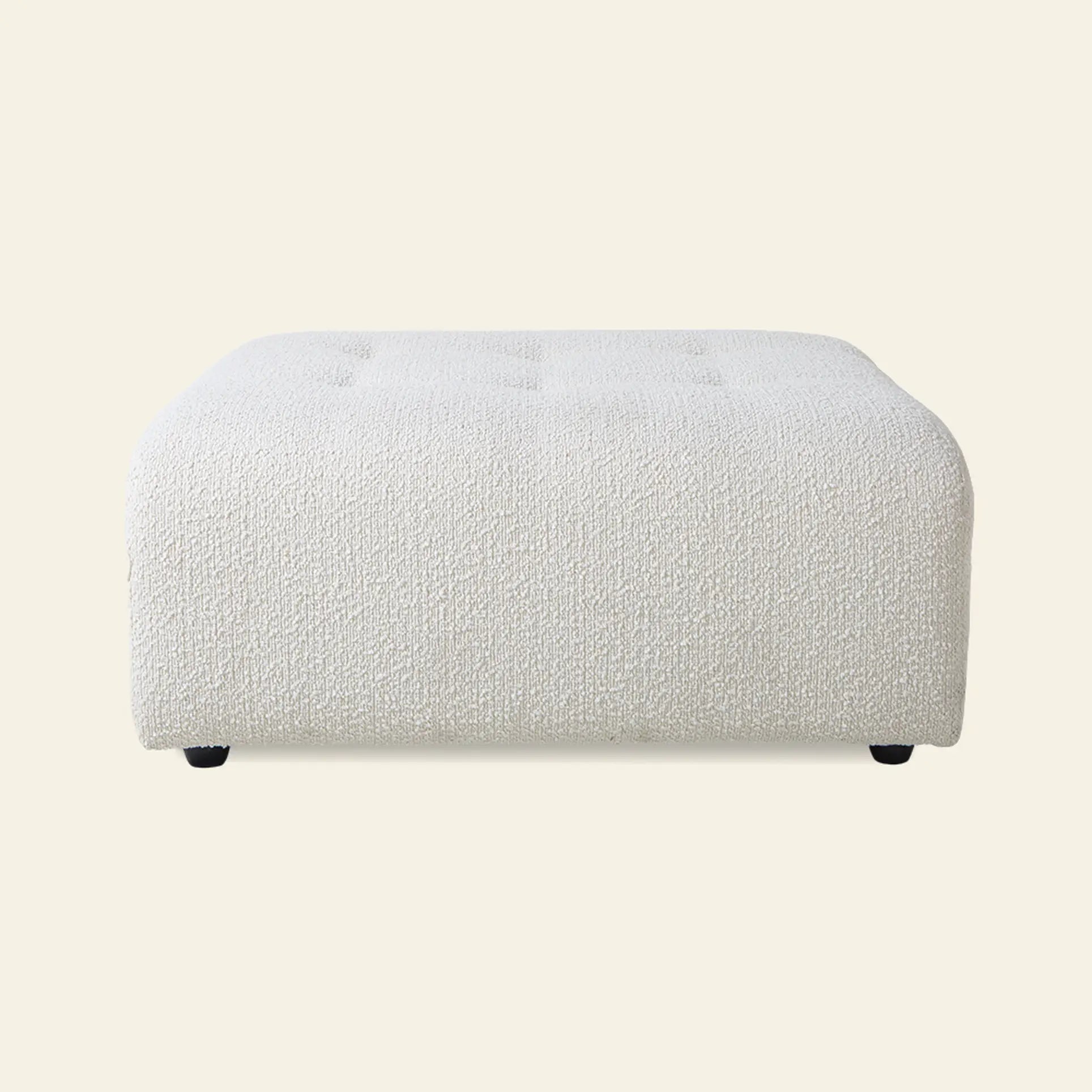 The HKliving Vint Couch Hocker, a square textured white ottoman with rounded edges and subtle top tufting, offers customizable seating against a plain light background.