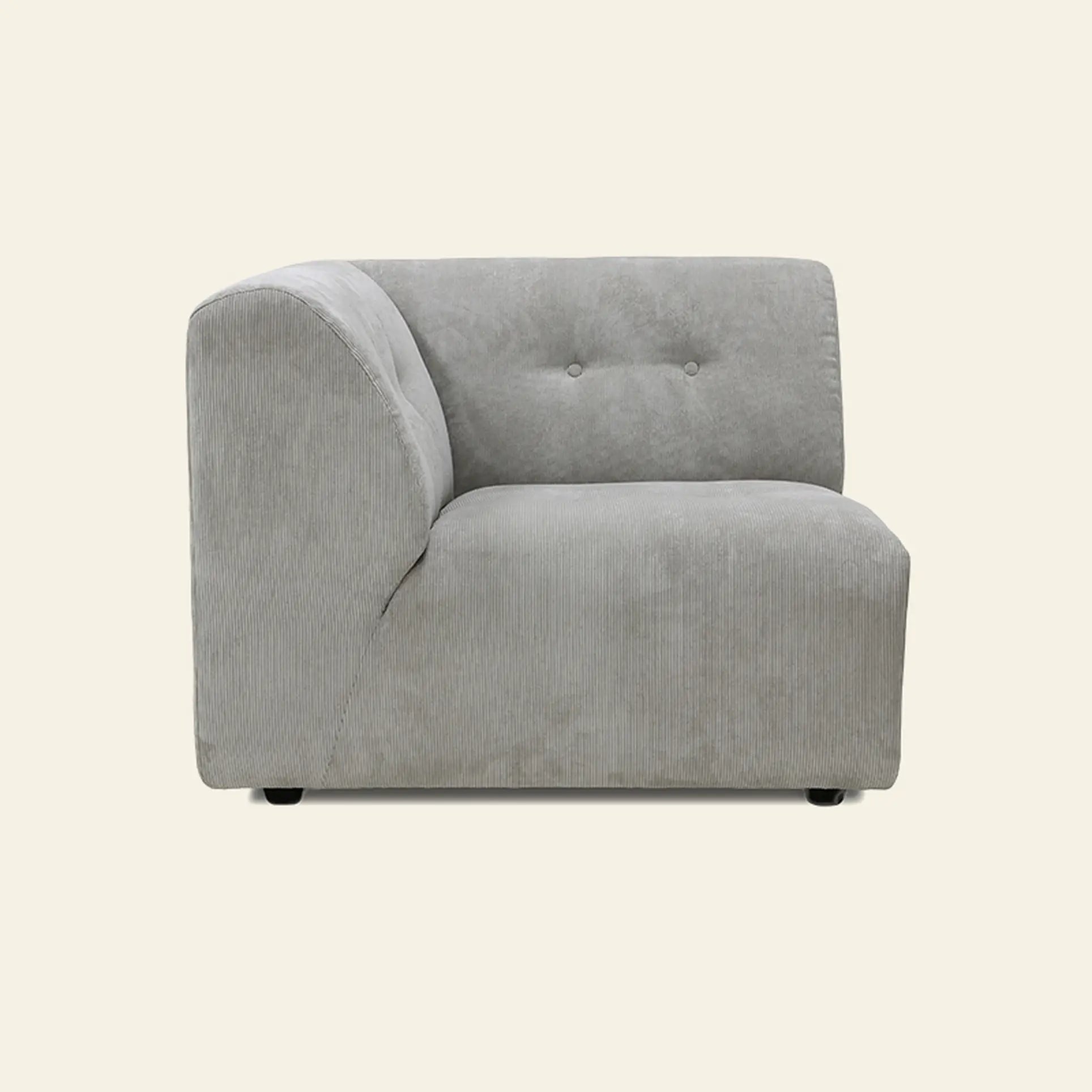 The HKliving Vint Couch, Left by HKliving is a modern light gray upholstered corner chair with a tufted backrest. Its minimalist design features clean lines and modular components for a customizable living space. Photographed against a beige background.