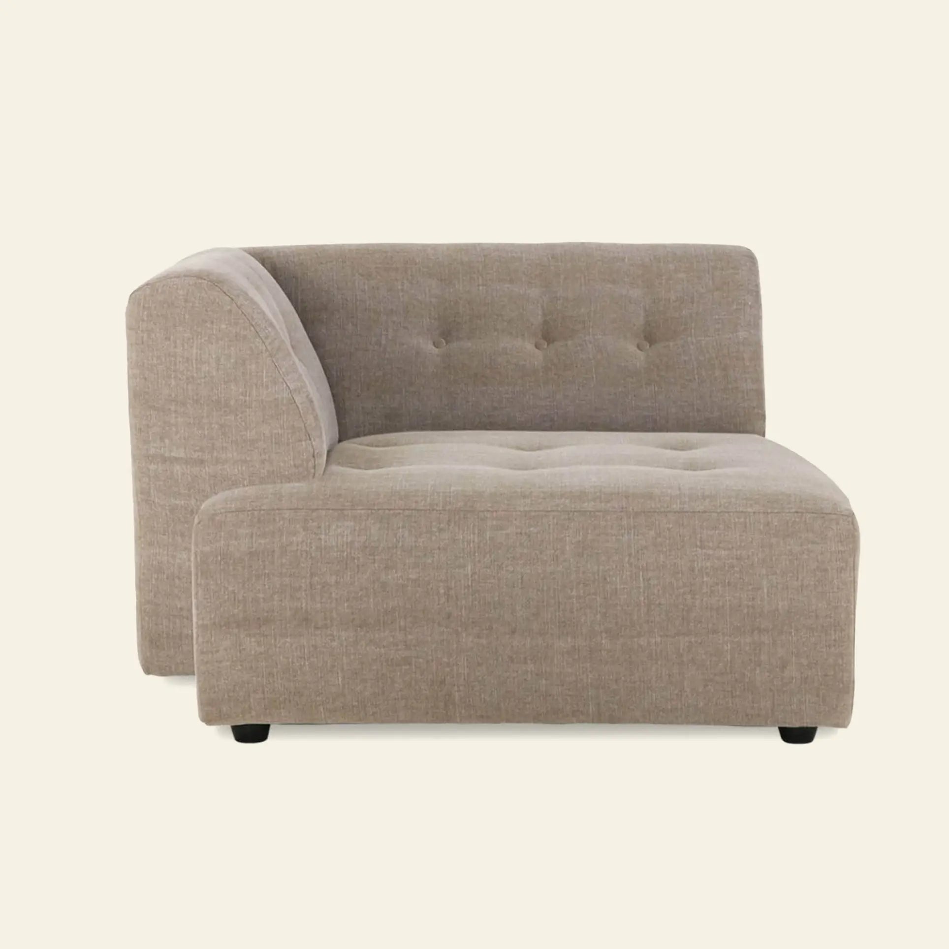 The HKliving Vint Couch, Left Divan is a modern beige sectional with tufted back and seat cushions, shown from the side on a light background—ideal for a customizable living space with adaptable components.
