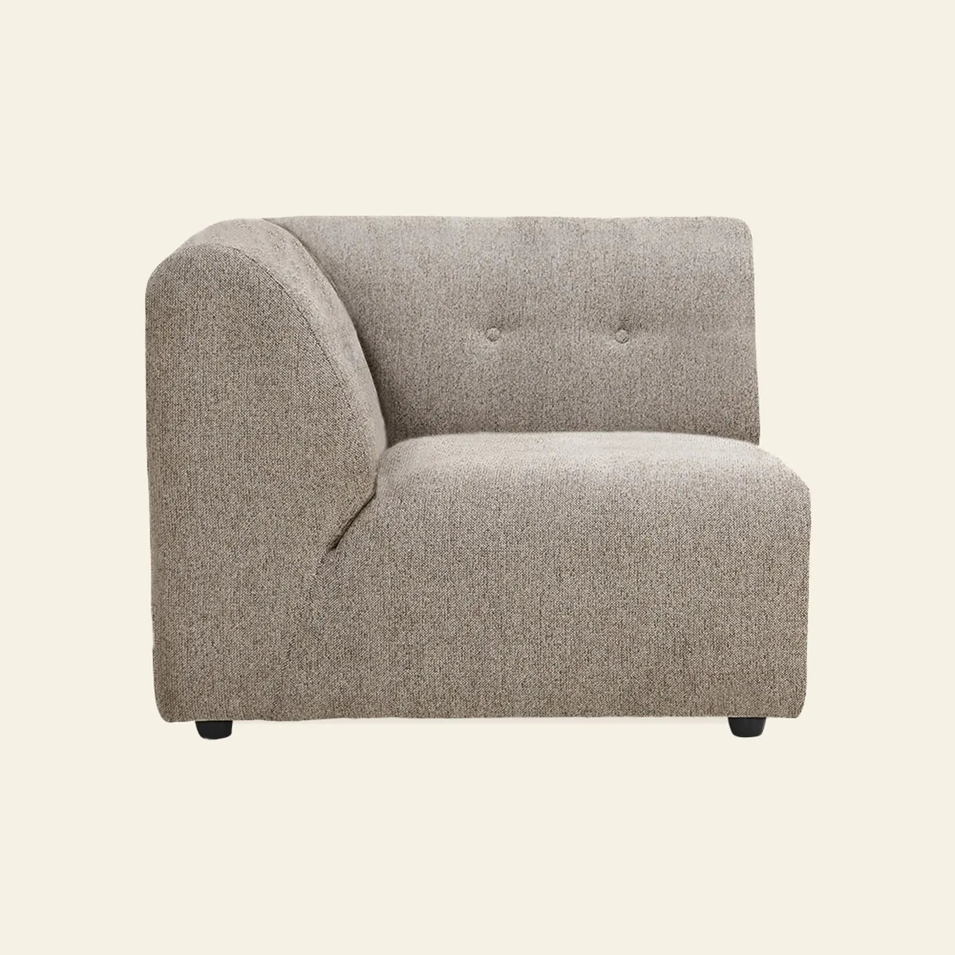 The HKliving Vint Couch, Left by HKliving is a modern, light brown sectional with a tufted backrest and short black legs, offering adaptable components for a customizable living space, set against a plain beige background.