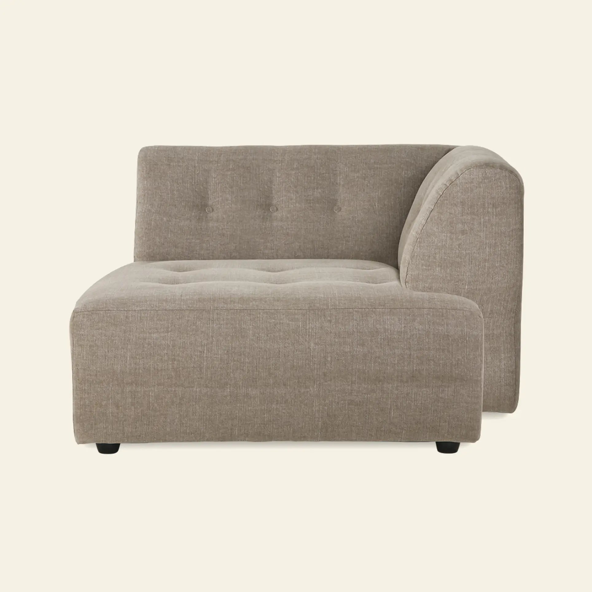 The HKliving Vint Couch, Right Divan, by HKliving, is a modern beige sectional with tufted seat and backrest, right-side armrest, and short black legs. Its adaptable design lets you easily customize any living space. Set against a plain light background.
