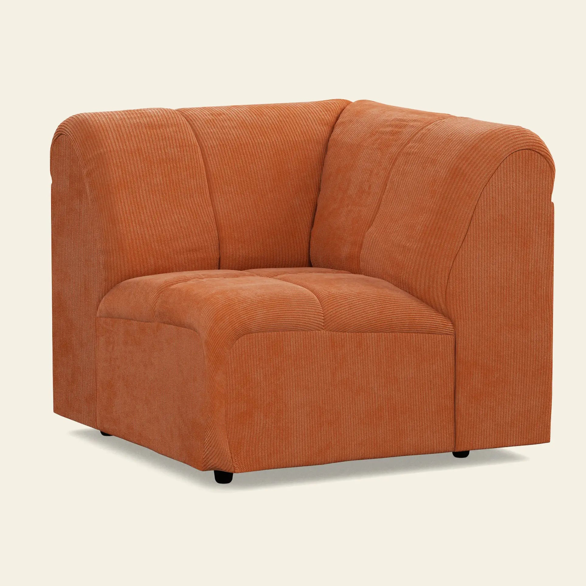 The HKliving Wave Couch, Corner by HKliving is a modern orange corduroy chair with plush cushioning and rounded edges, making it a standout piece of living room furniture against a plain light background.