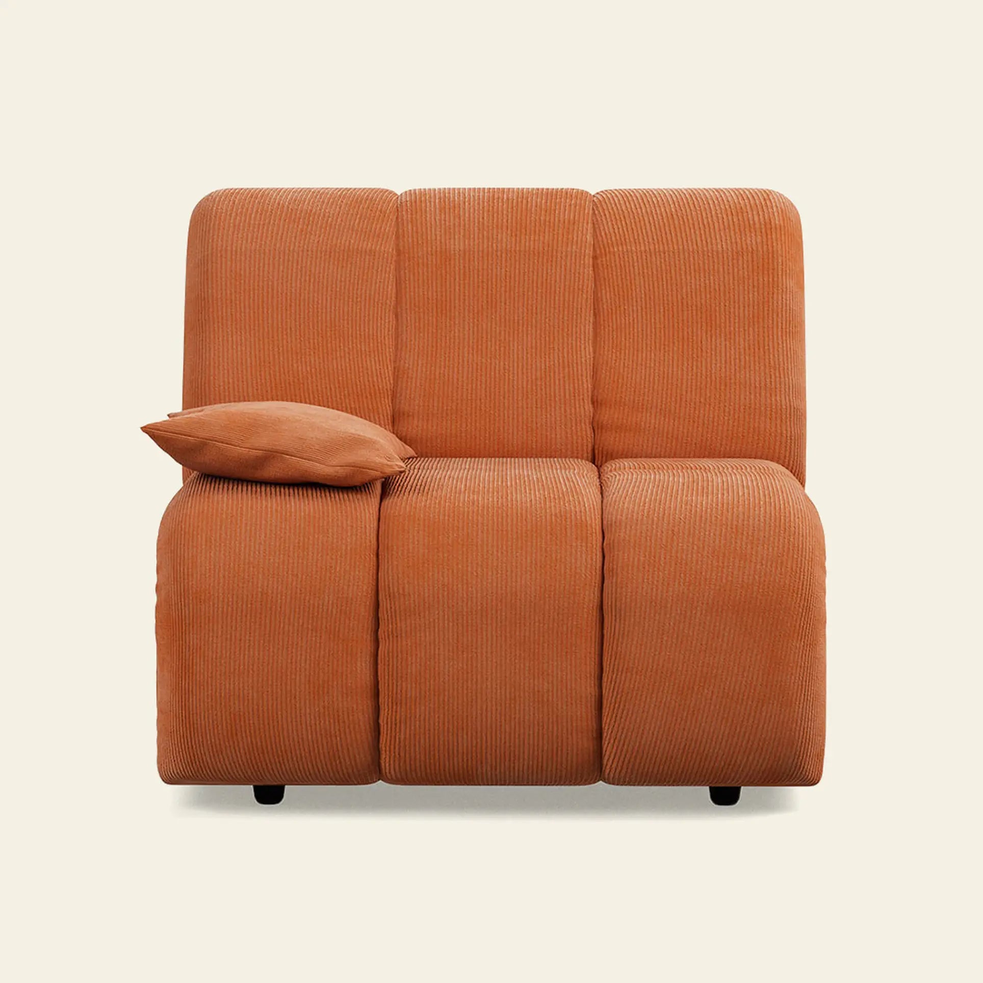 The HKliving Wave Couch, Left Low Arm, by HKliving, features orange corduroy-like fabric and a matching pillow. Its modern design brings vibrant color to your living room and suits any accent against a plain light background.