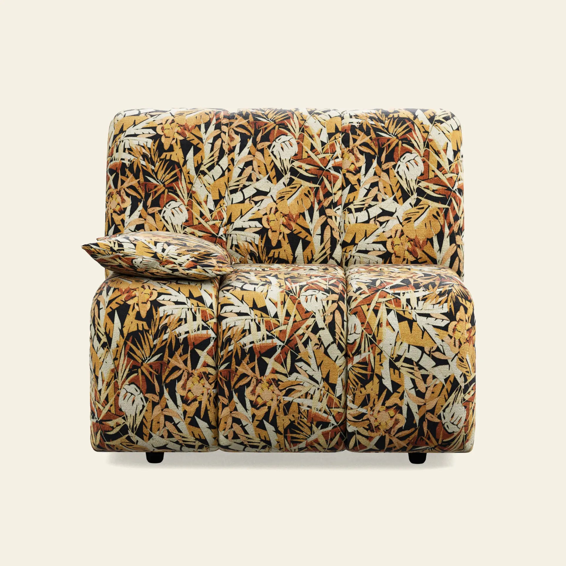 The HKliving Wave Couch, Left Low Arm, is a two-seater with a vibrant jungle print of yellow, orange, brown, and black tropical leaves. A matching pillow sits on the left side. The plain background highlights its bold HKliving design.