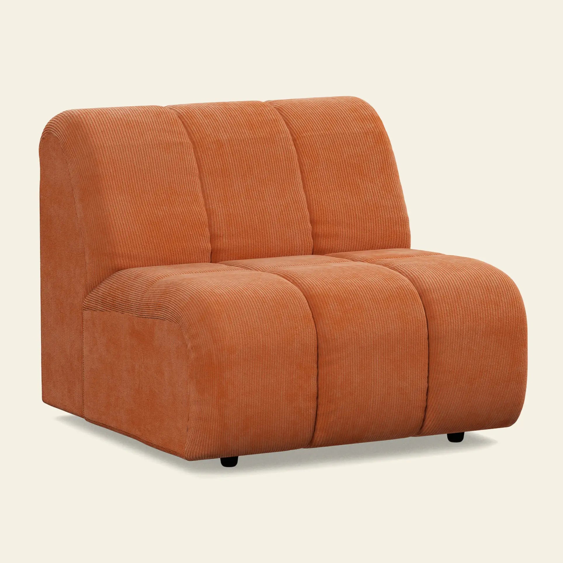 The HKliving Wave Couch, Middle by HKliving is a modern armless accent chair, inspired by 1970s design, with ribbed orange upholstery, a low wide seat, and a gently curved backrest featuring vertical stitched sections.