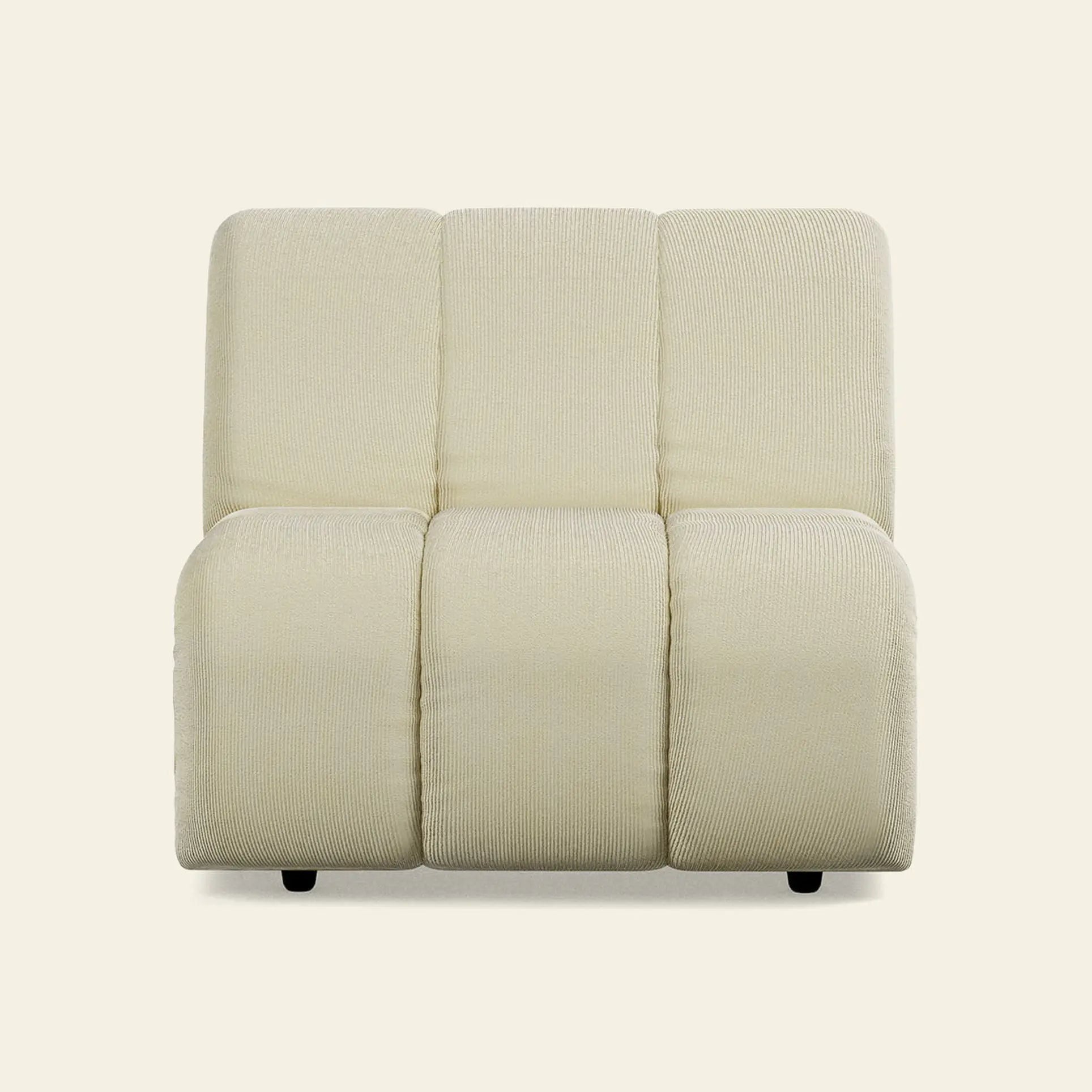 The HKliving Wave Couch, Middle by HKliving is a modern, armless accent chair inspired by 1970s design, featuring textured light beige upholstery and three wide cushioned segments on the backrest and seat against a neutral background.