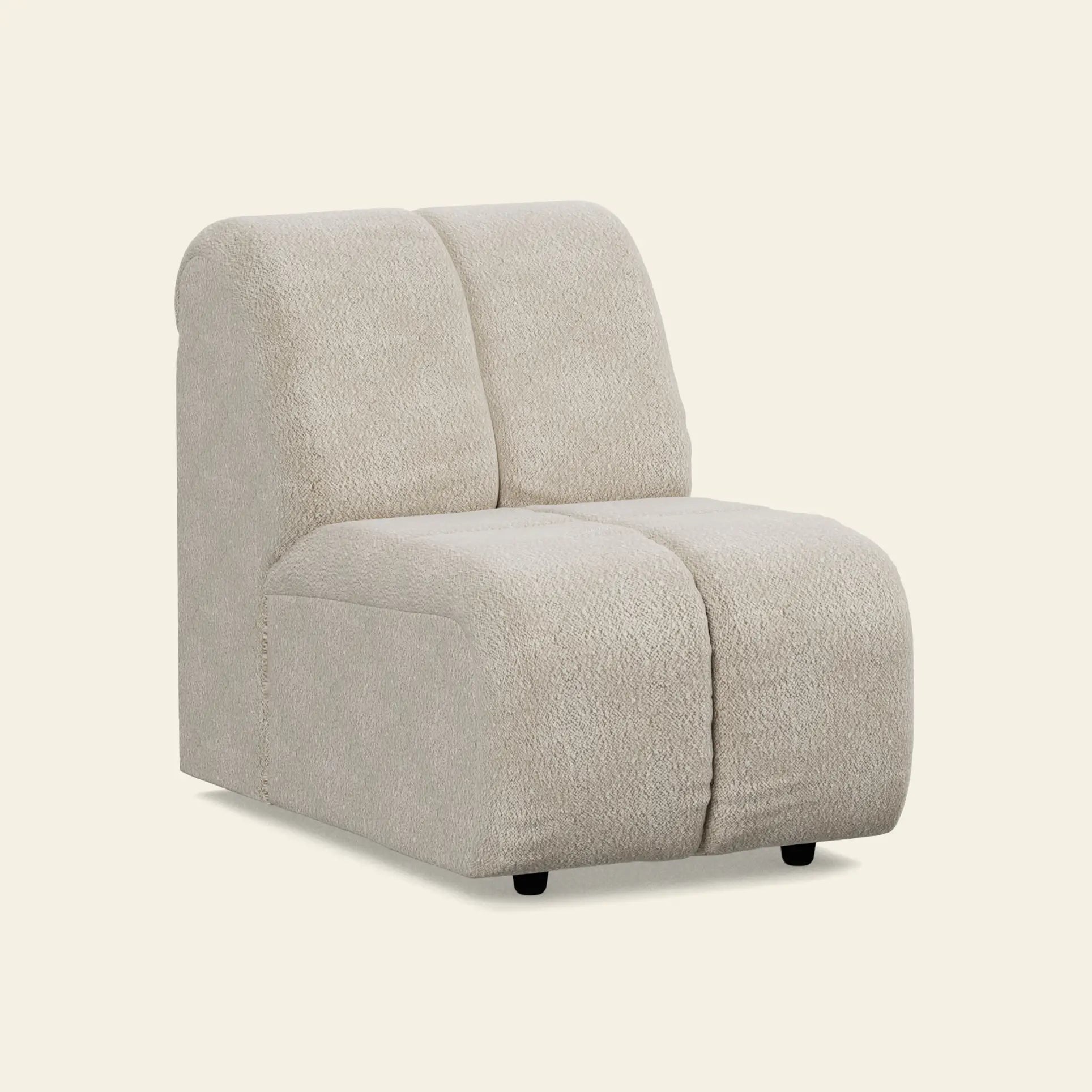 The HKliving Wave Couch, Middle Small by HKliving is a 1970s-inspired armless accent chair with a curved backrest and seat, upholstered in textured beige fabric featuring subtle vertical seams, set against a plain light background.