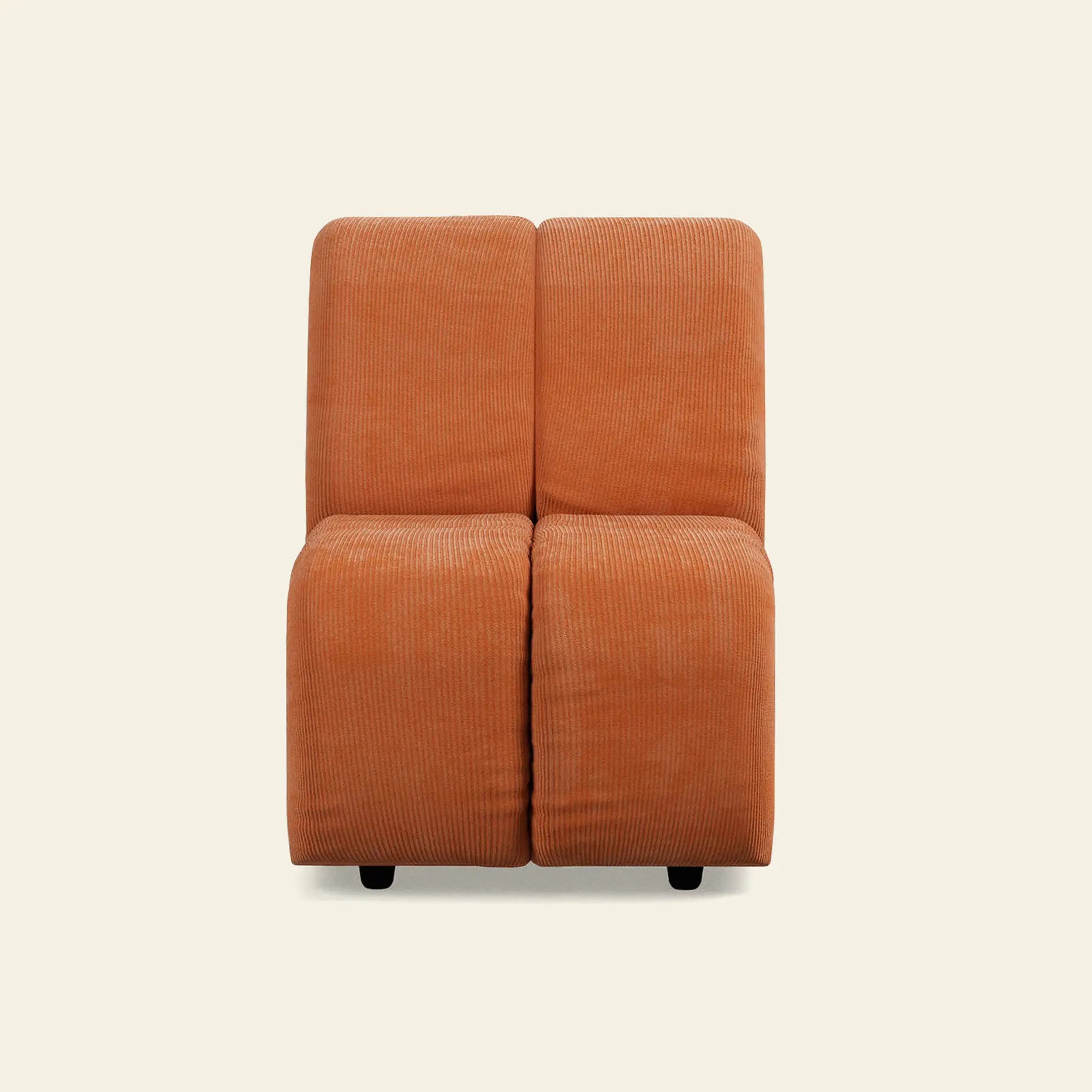 The HKliving Wave Couch, Middle Small is a modern armless chair with rust-orange corduroy upholstery, 1970s-inspired boxy minimalist design, and four short black legs, shown against a plain light beige background.