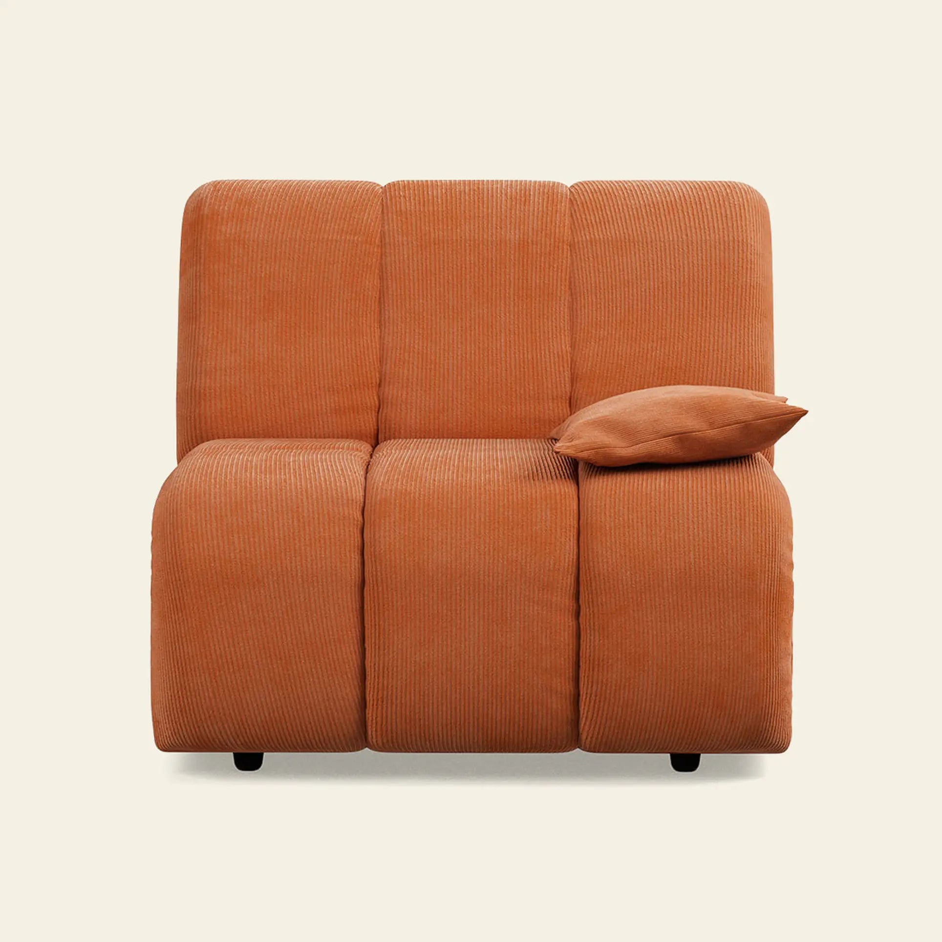 The HKliving Wave Couch, Right Low Arm by HKliving is an orange corduroy armless loveseat with three seats and a matching right-side pillow. Its modern design and plain light backdrop make it perfect stylish living room furniture.