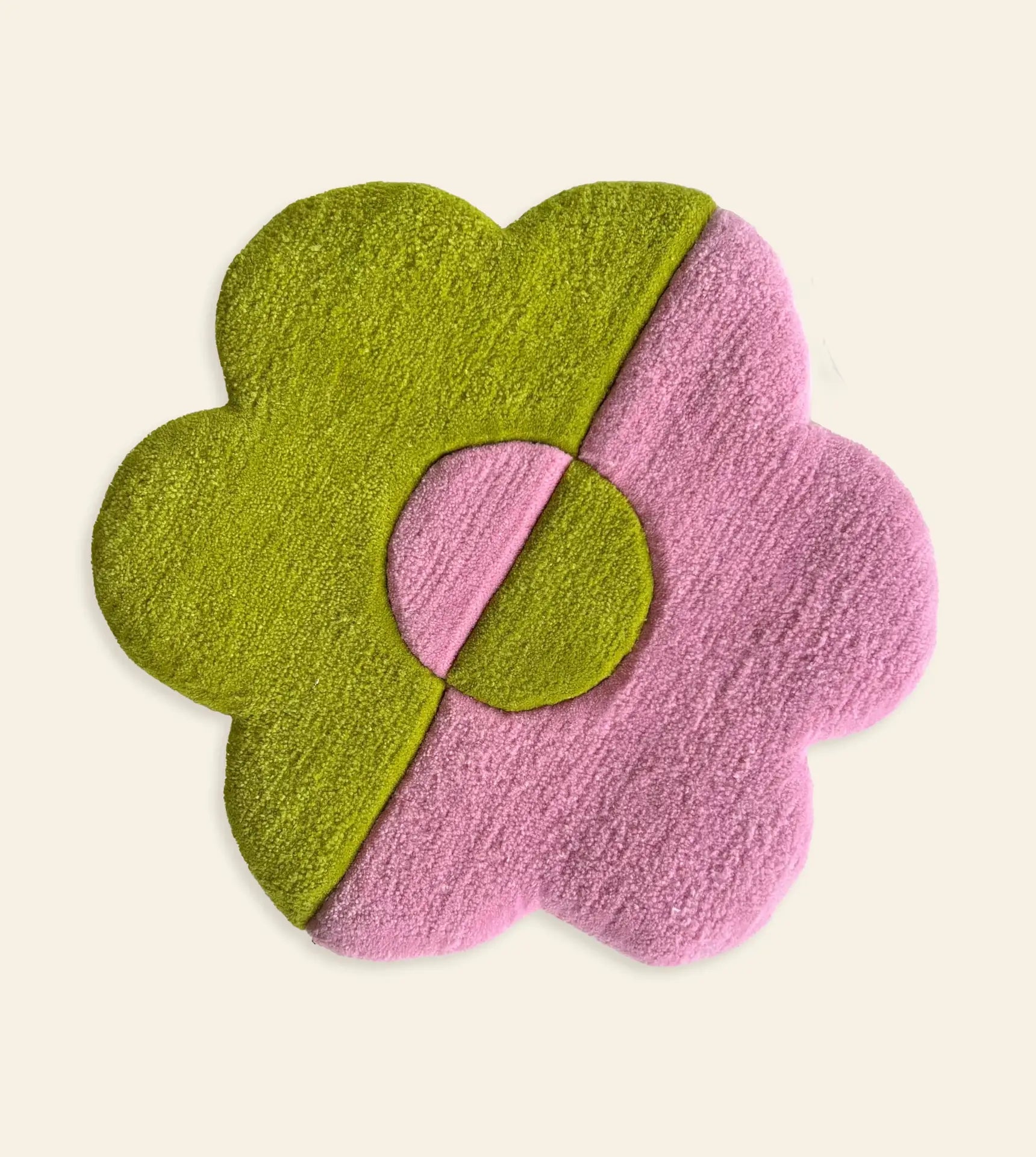 The Habichl Tufted Flower Floor Rug by Habichl features five petals in a playful green-and-pink split design, including the center, set on an off-white background—bringing whimsical charm to any room.
