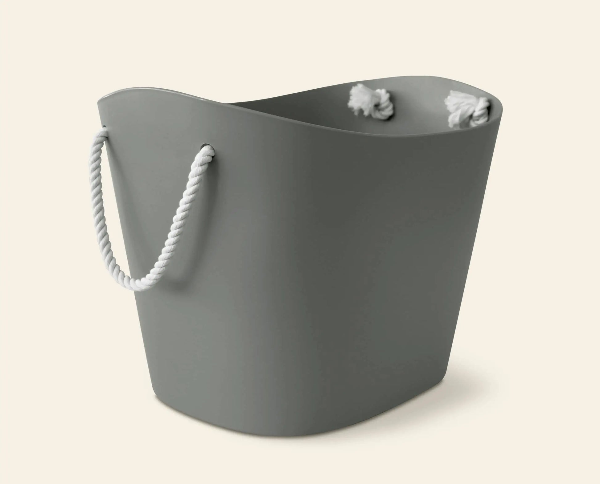 The Hachiman Balcolore Storage Basket M is a gray, flexible tub with a wavy rim and white rope handle, perfect for minimalist Japanese homes. Shown against a plain, light background.