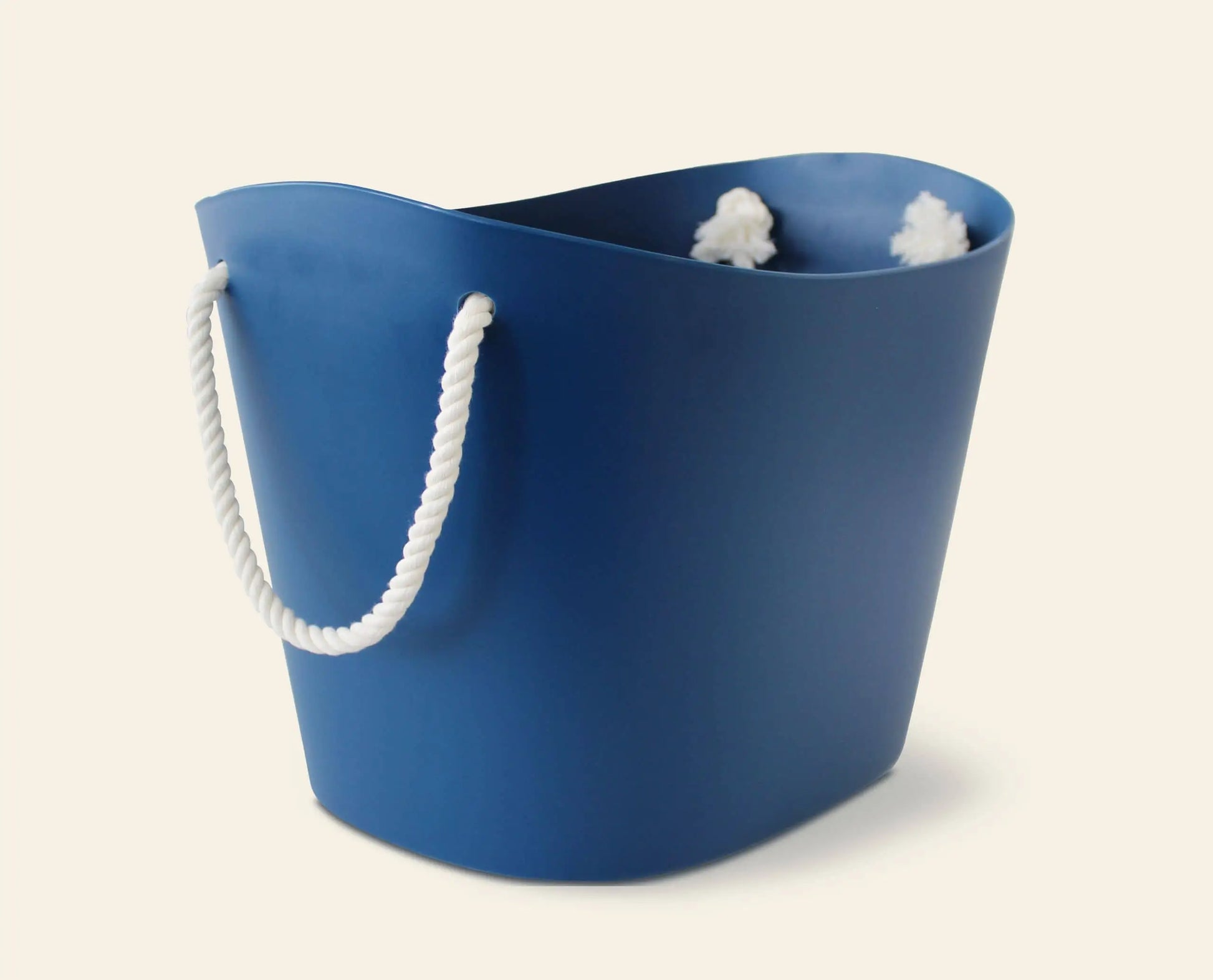 The Hachiman Balcolore Storage Basket M by Hachiman is a blue, oval basket with white rope handles and a smooth finish—ideal for minimalist Japanese-style interiors and stands out against a light background.