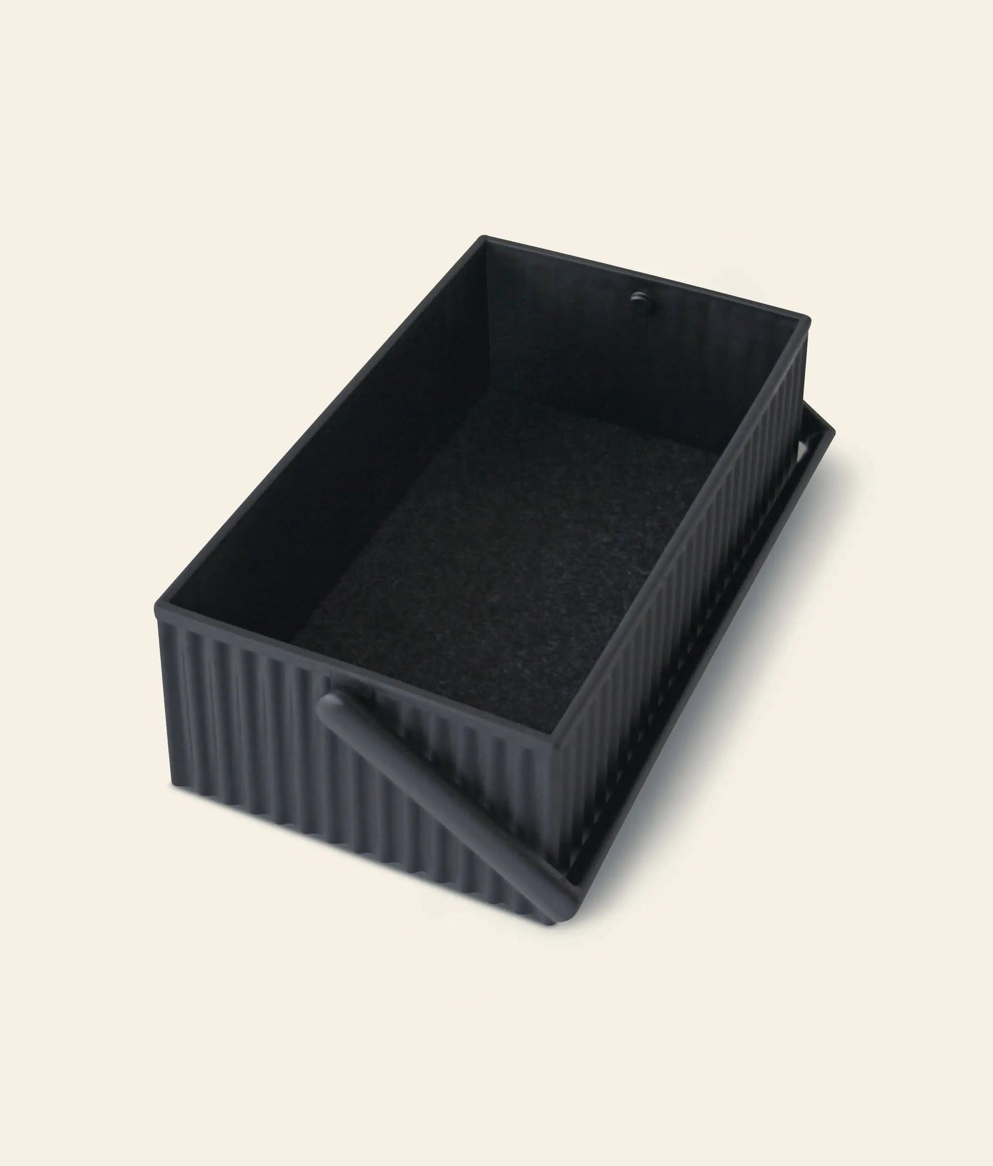 The Hachiman Omnioffre Stackable Storage Box S by Hachiman is a rectangular, black, ribbed minimalist organizer with a matching hinged lid, partially open to show its dark interior, set against a light background.