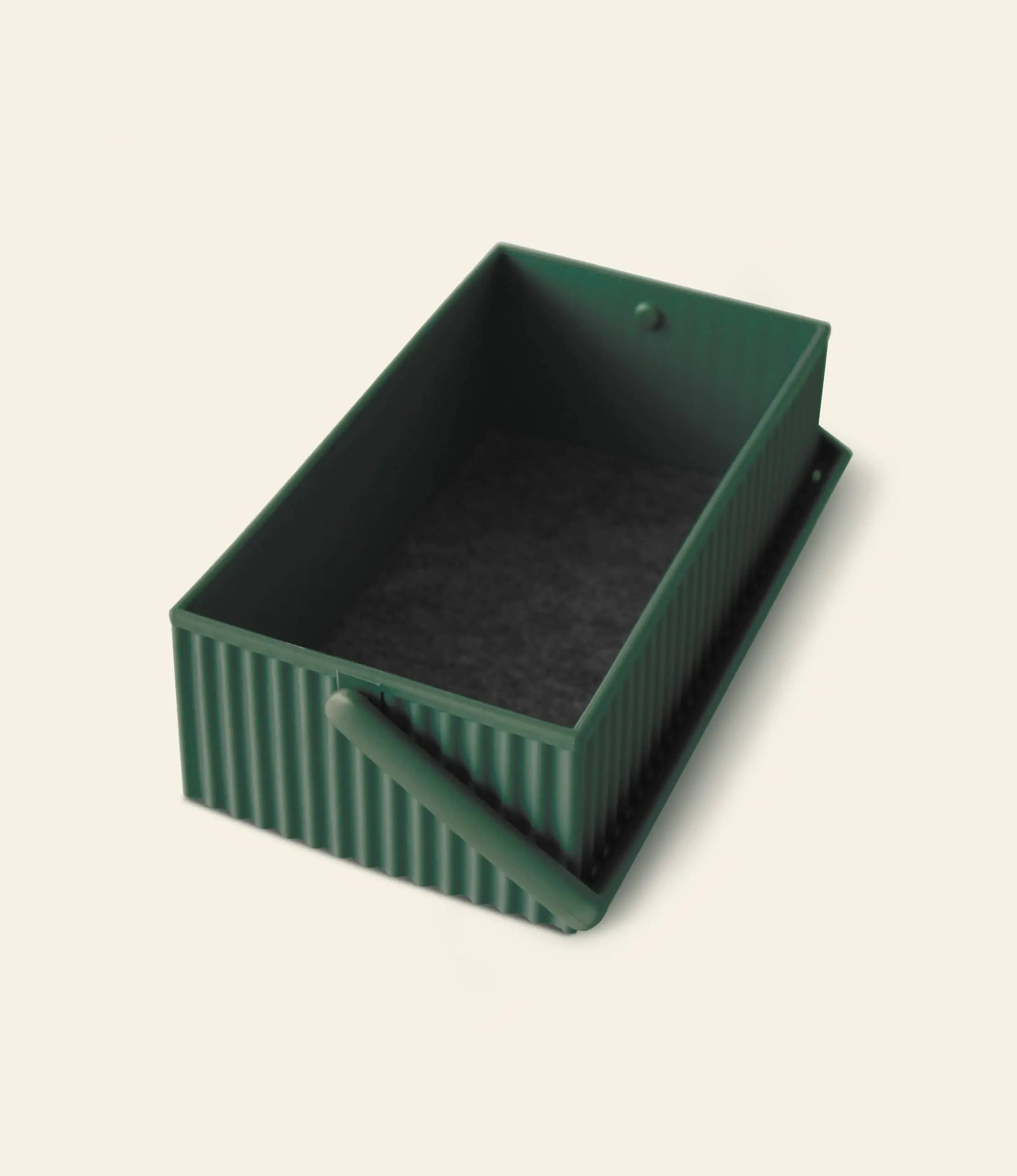 The Hachiman Omnioffre Stackable Storage Box S by Hachiman is a rectangular, dark green, ribbed minimalist box with an open top and matching side handle, shown on a light background for a modern touch.