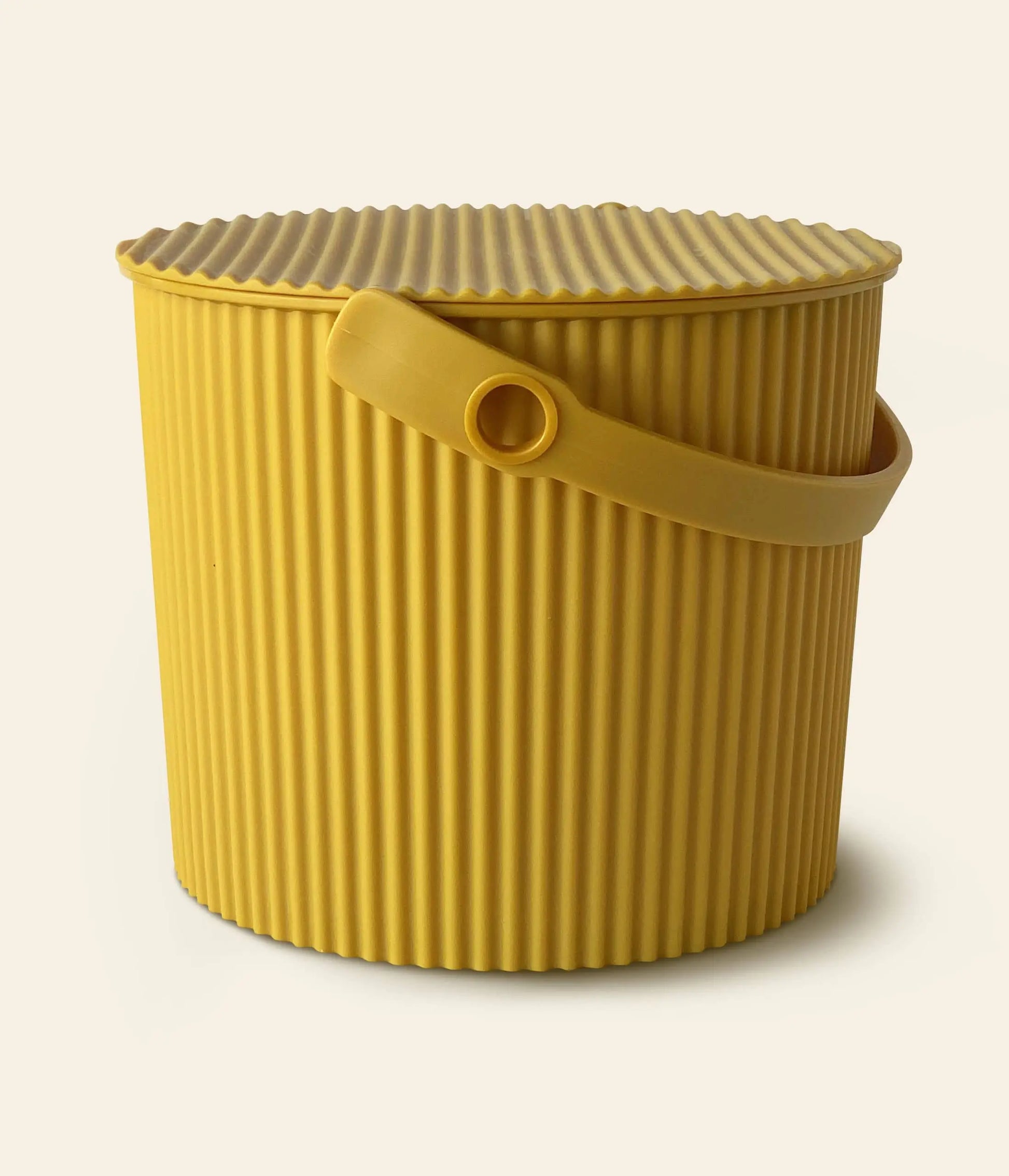 The Hachiman Omnioutil Storage Bucket S by Hachiman is a yellow, ribbed container with a matching lid and side handle, suitable for indoor or outdoor use, shown on a plain light background.
