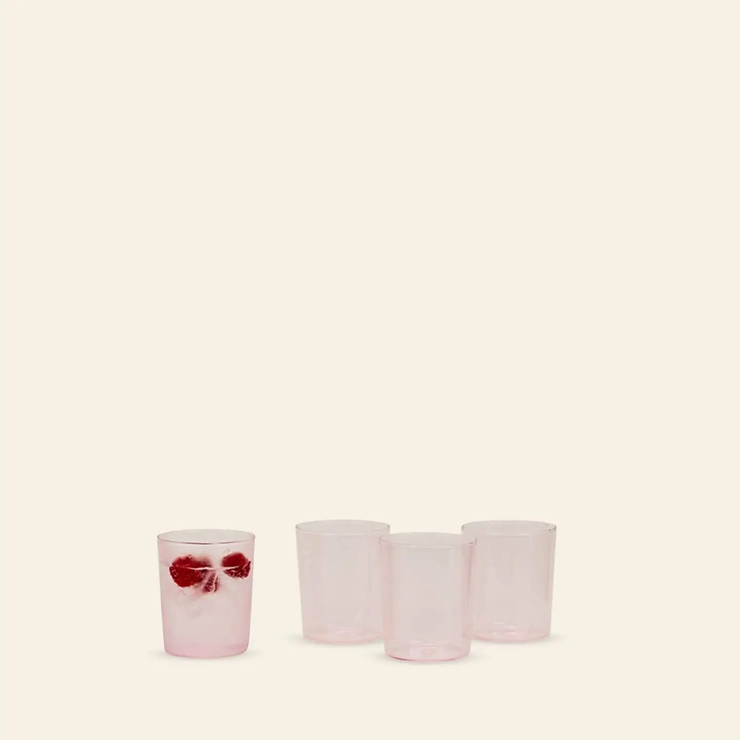 Four Hawkins New York Essential Glassware, Set Of 4, Medium glasses are shown on a plain background—three empty, one filled with a drink, ice cubes, and red fruit—highlighting their premium glass construction.