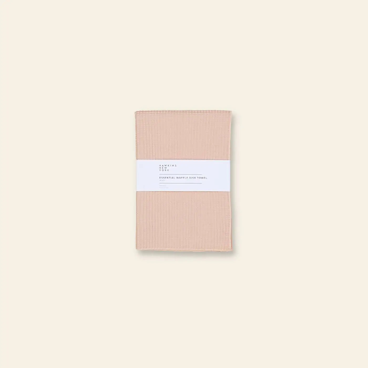 A set of two light beige Hawkins New York Essential Waffle Dish Towels is centered on a neutral background, wrapped in a white label.
