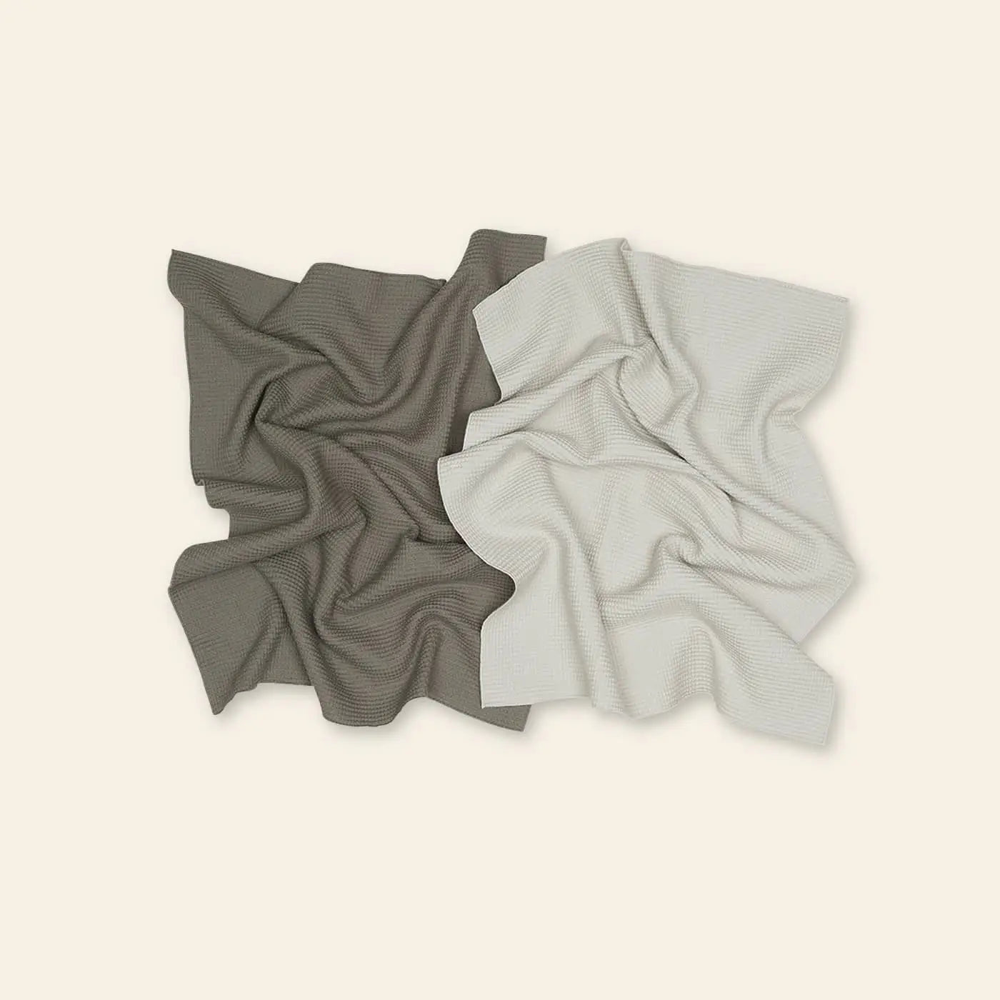 The Hawkins New York Essential Waffle Dish Towel Set Of 2 features one dark brown and one light beige towel, artfully crumpled side by side on a plain light background.