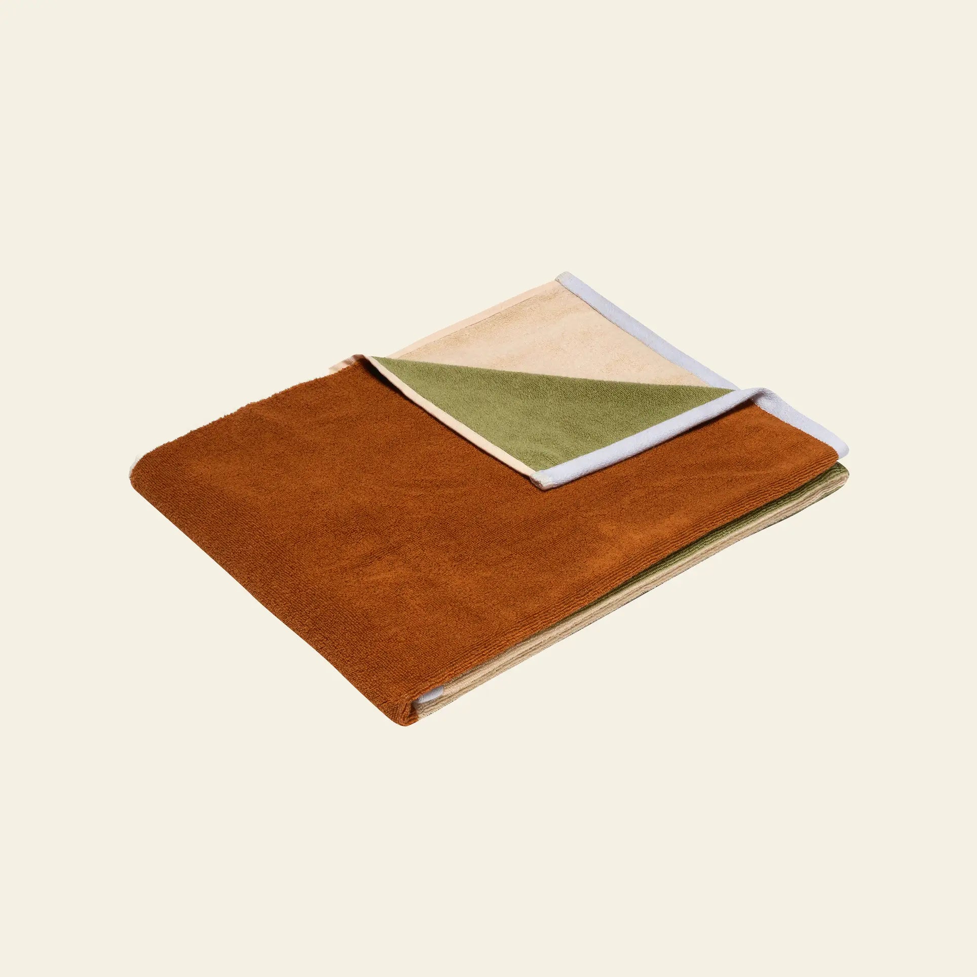 The Hübsch Block Towel Large by Hübsch, made from STANDARD 100 By Oeko-Tex cotton, showcases a rust-colored exterior with beige, olive green, and white inner panels—an elegant choice for your bathroom textiles collection.