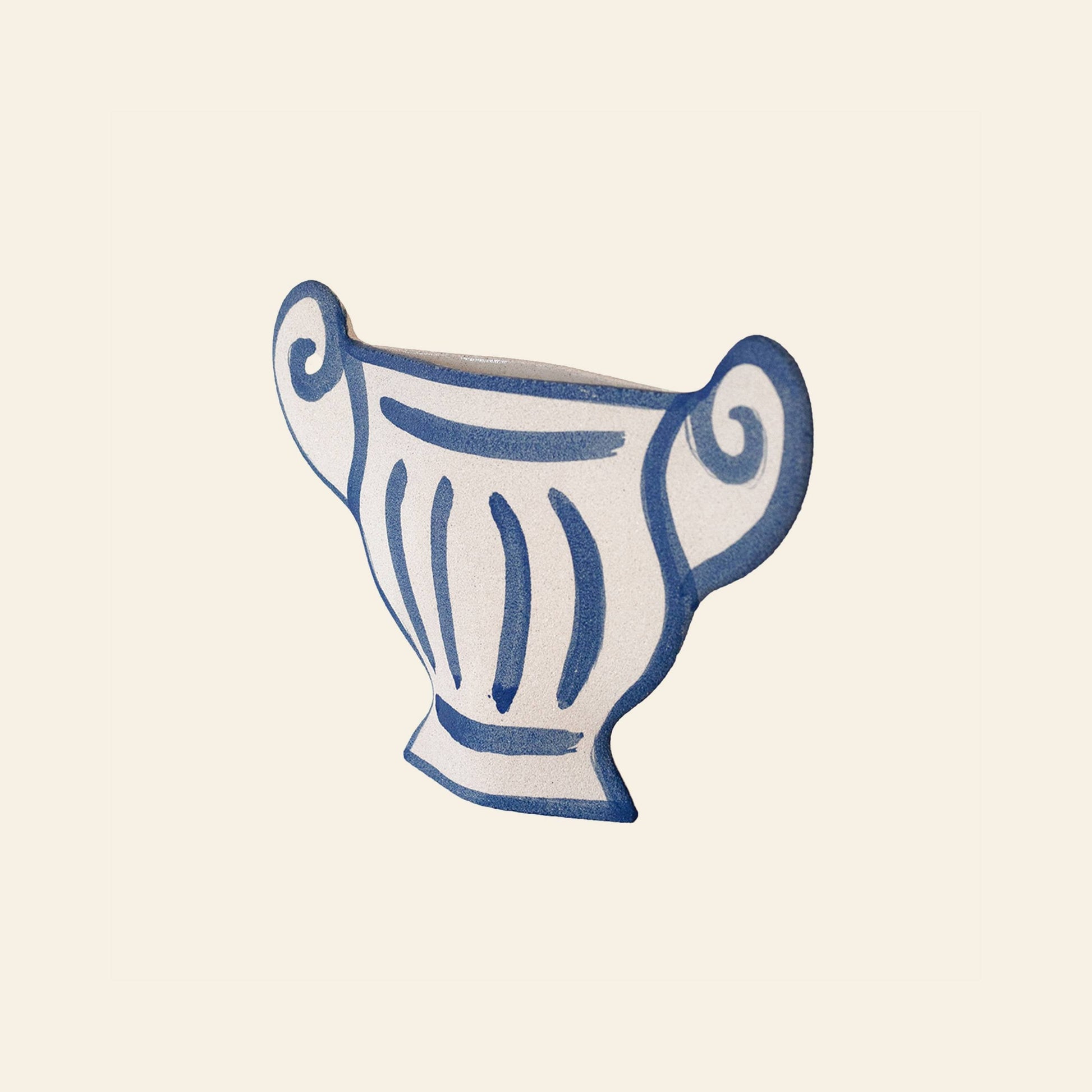 The INI CERAMIQUE Greek Coupe Ceramic Vase features a stylized, hand-drawn white design with blue outlines and swirled handles, reminiscent of ancient Greek pottery, displayed on a plain light background.