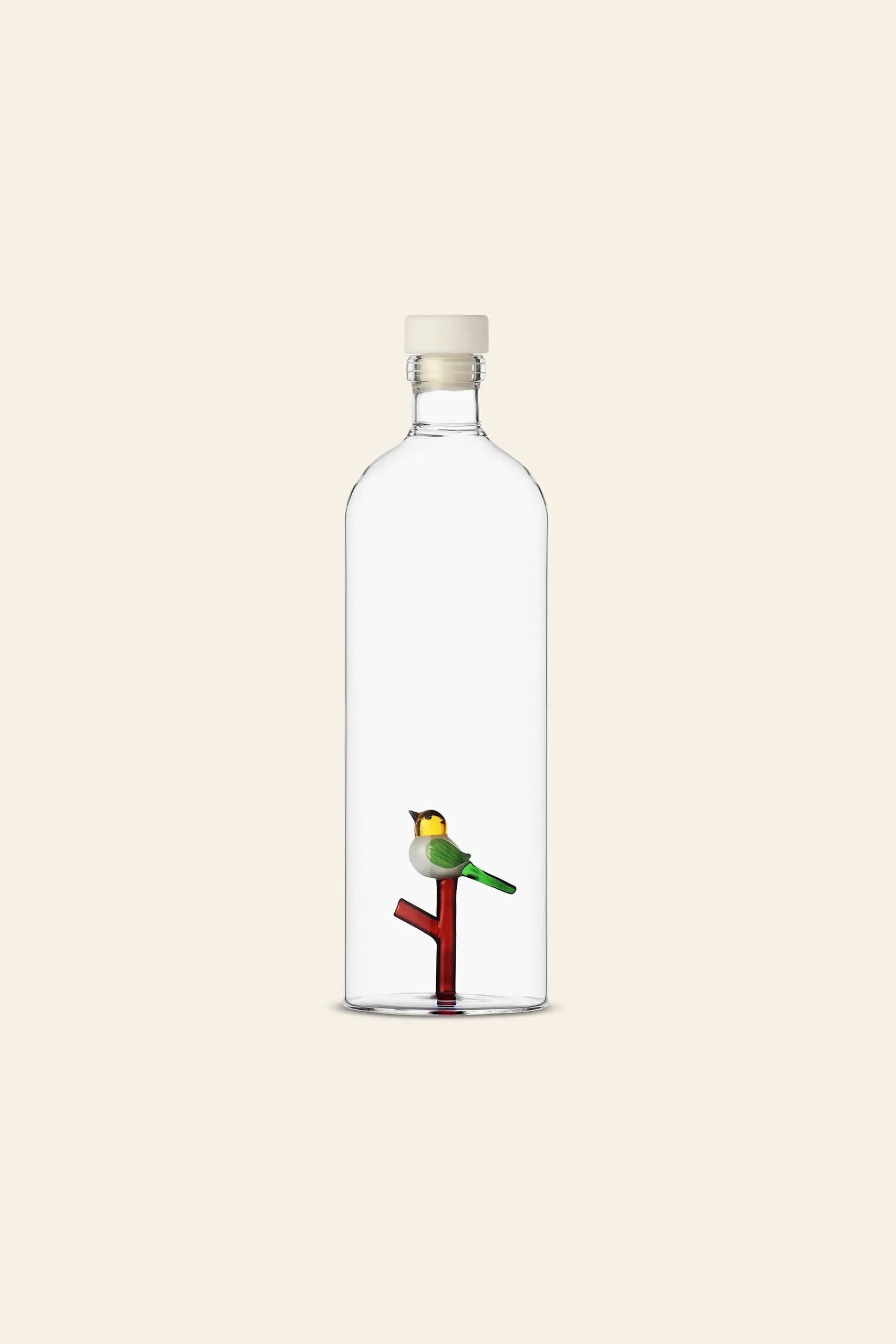 The Ichendorf Milano Animal Farm Bottle by Ichendorf Milano features a unique glass design with a white cap, showcasing a colorful bird on a red and green branch against a beige background—perfect for handcrafted glassware enthusiasts.