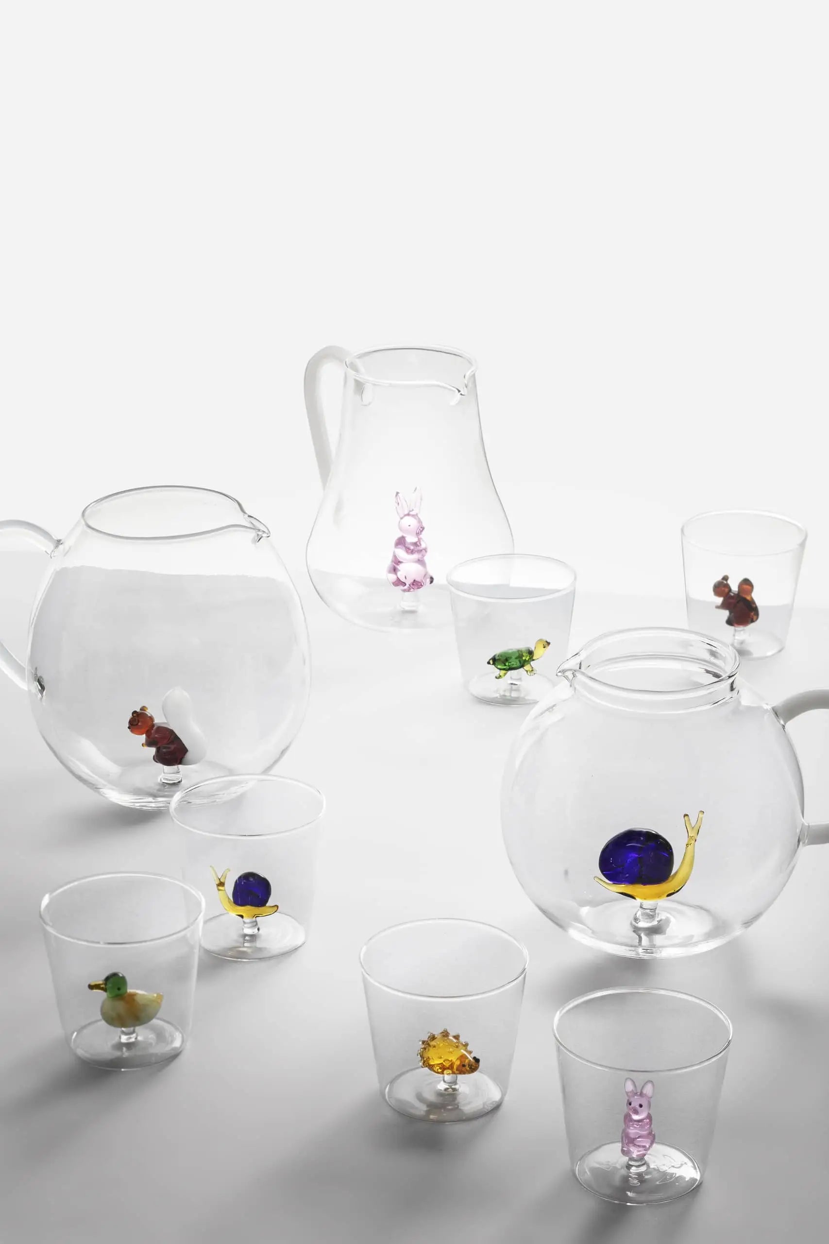The Ichendorf Milano Animal Farm Tumbler by Ichendorf Milano features clear glass with a tiny, colorful animal figurine inside—like a rabbit or turtle—adding whimsy to your drinkware collection.