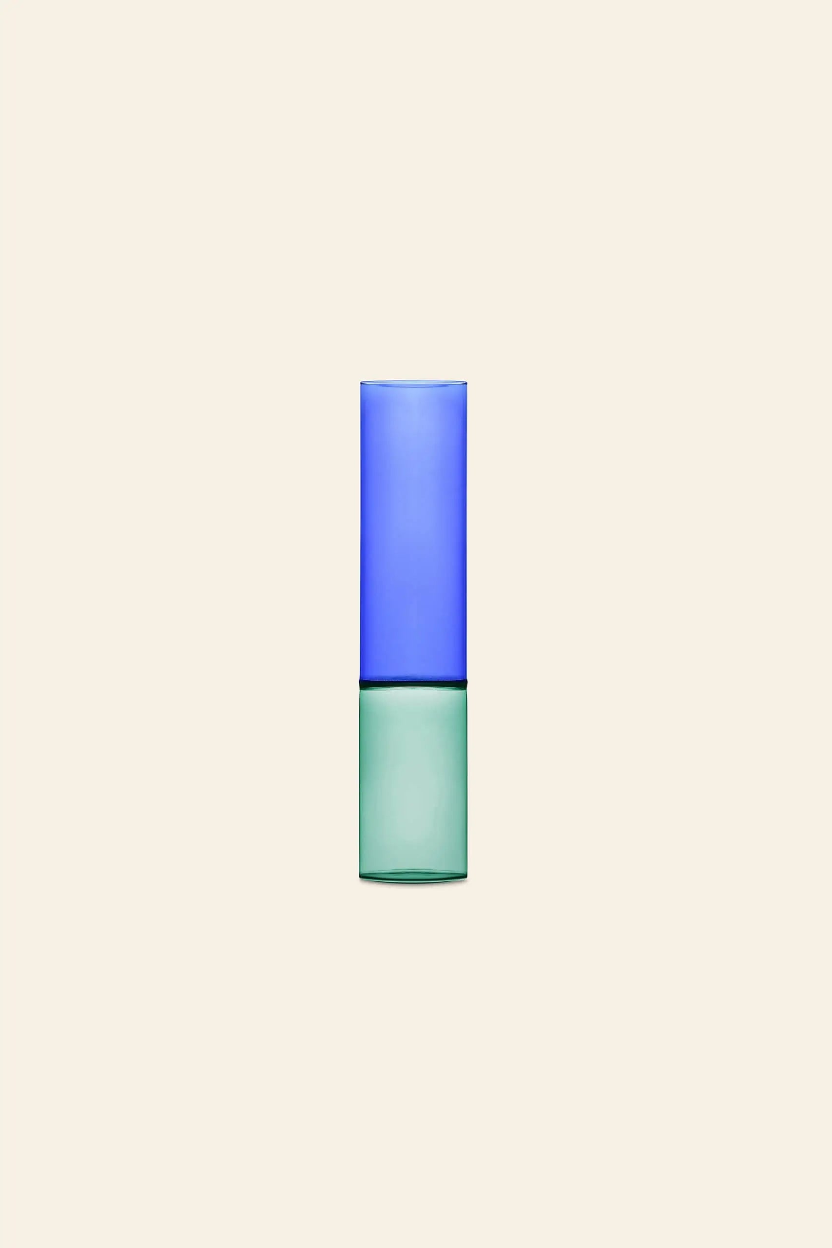 An Ichendorf Milano Bamboo Groove Vase 30cm in green with a blue glass stacked on top, displayed centered against a plain beige background.