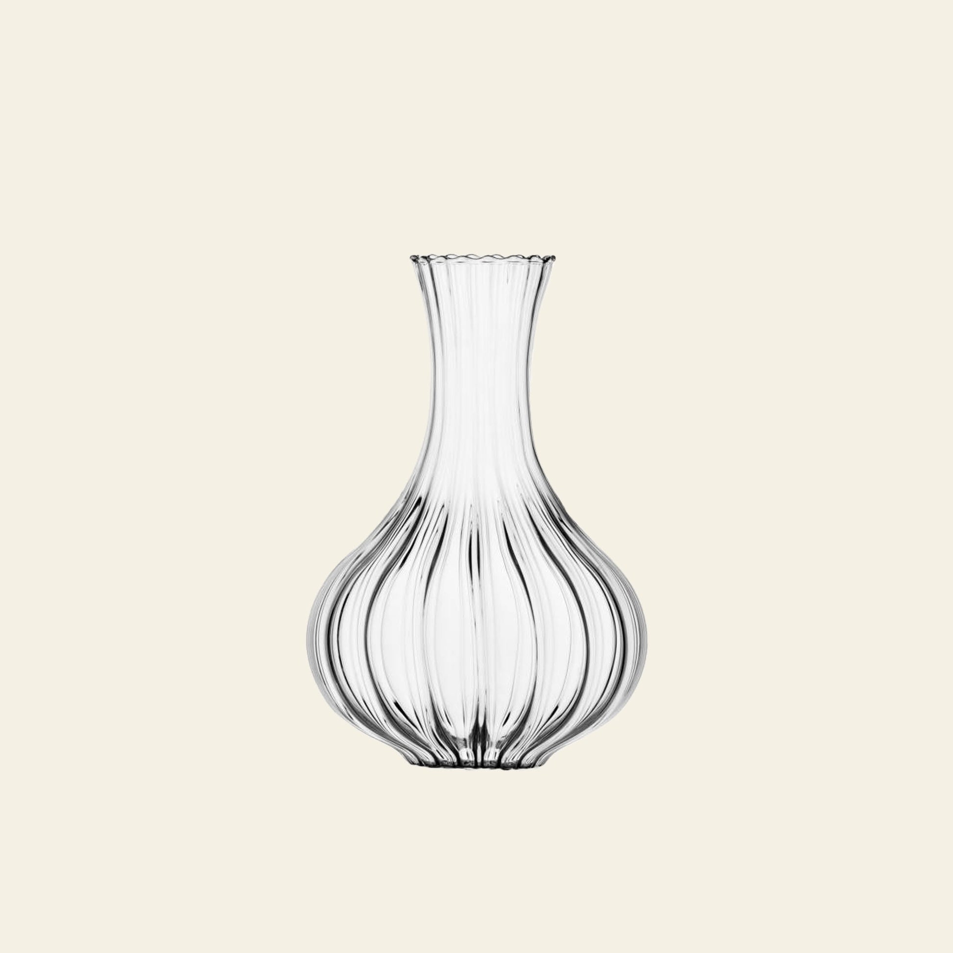 The Ichendorf Milano Bistrot Decanter by Ichendorf Milano features a ribbed, bulbous glass body and a narrow flared neck, crafted with blown glass technique and displayed against a plain light beige background.