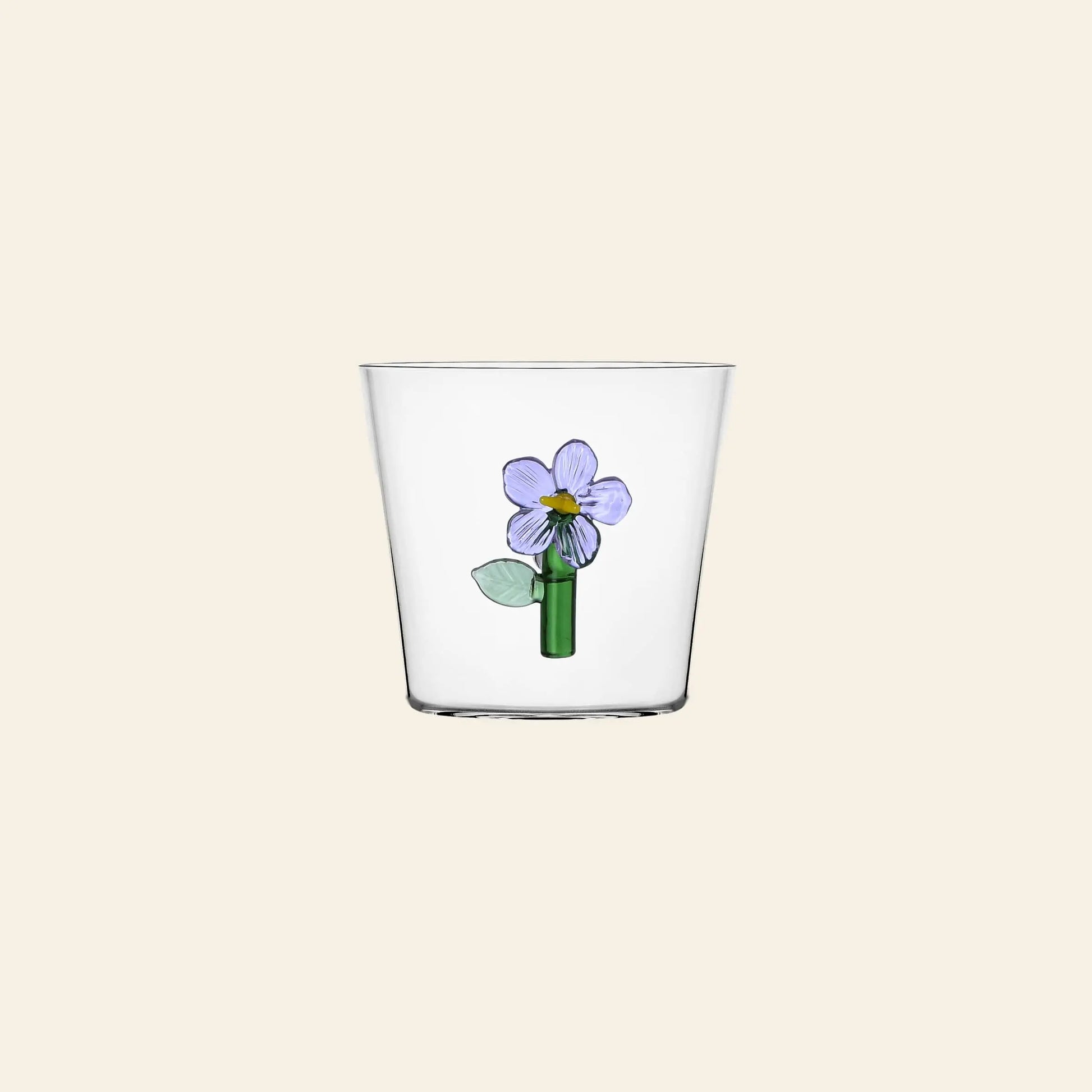 The Ichendorf Milano Botanica Tumbler - Lilac features a simple purple flower with green stem and leaves, adding nature-inspired charm from the Botanica collection by Ichendorf Milano to your table.
